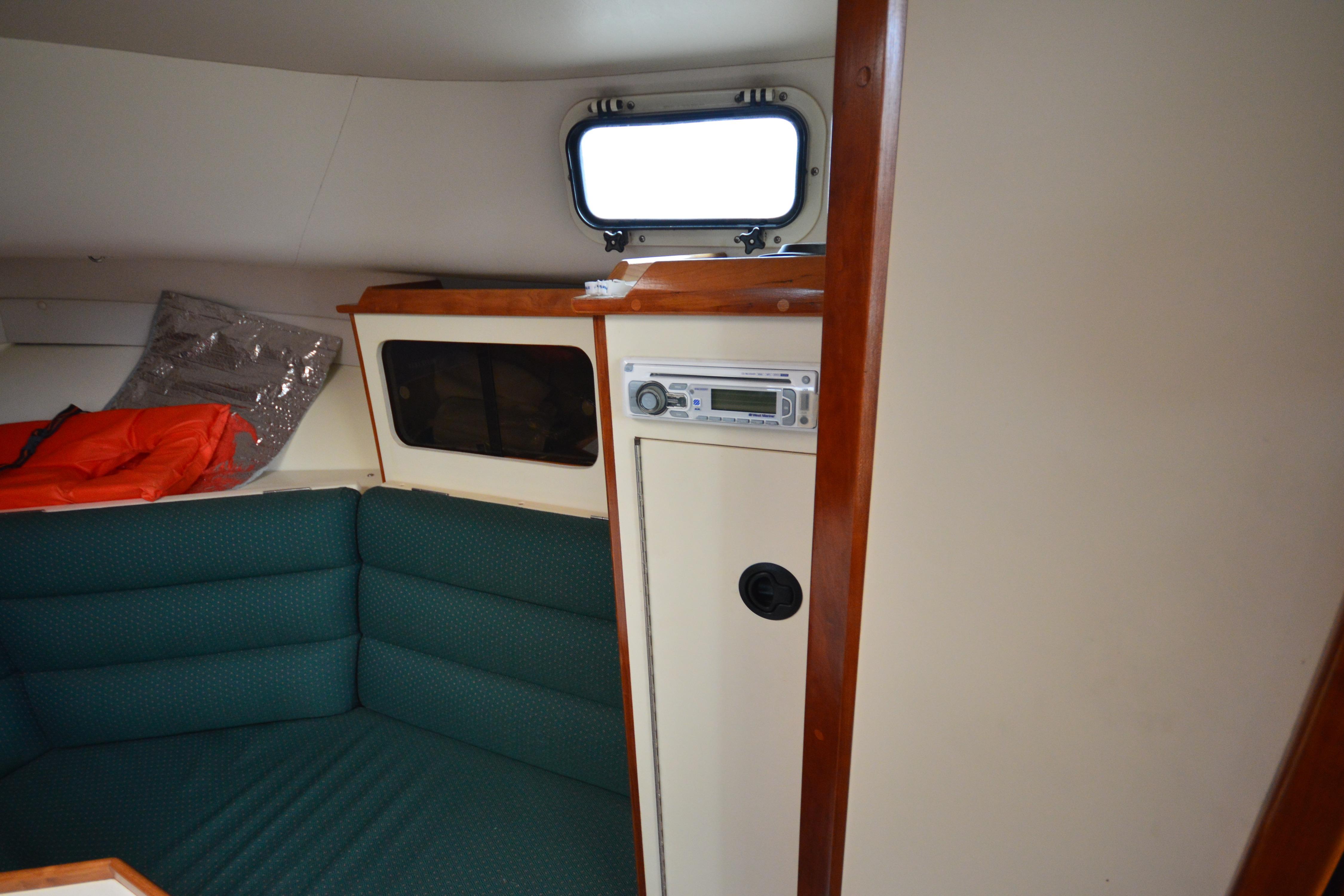 Interior of 2001 Albin 28 Tournament Express with green seating and wooden accents.