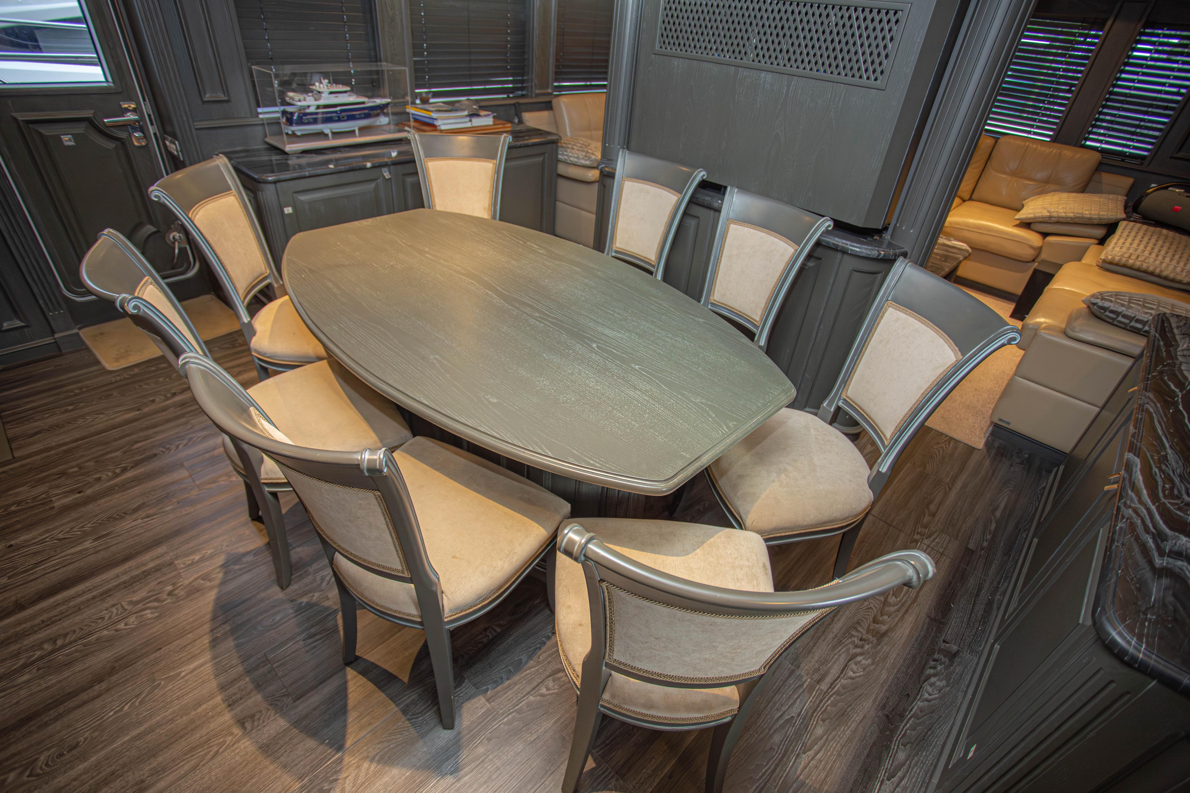 Luxurious dining area on 2014 Fifth Ocean Yachts 24m Explorer Yacht, featuring elegant seating.