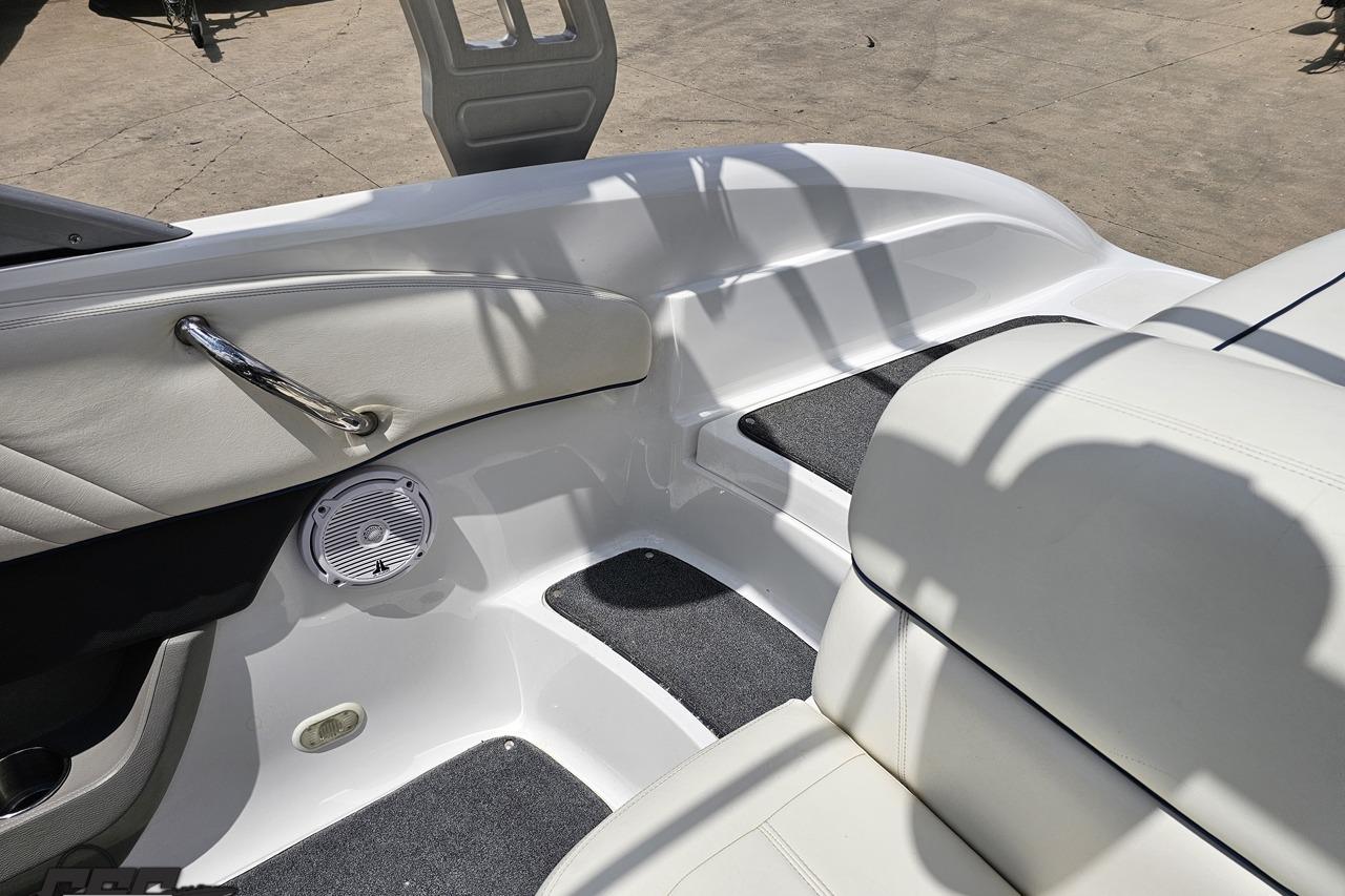 Interior of a 2010 Cobalt 232 WSS boat, featuring white seating and speaker.