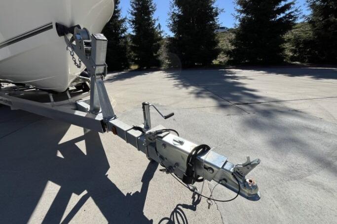 Trailer hitch of a 2025 Mako 214 Center Console boat in a sunny outdoor setting.