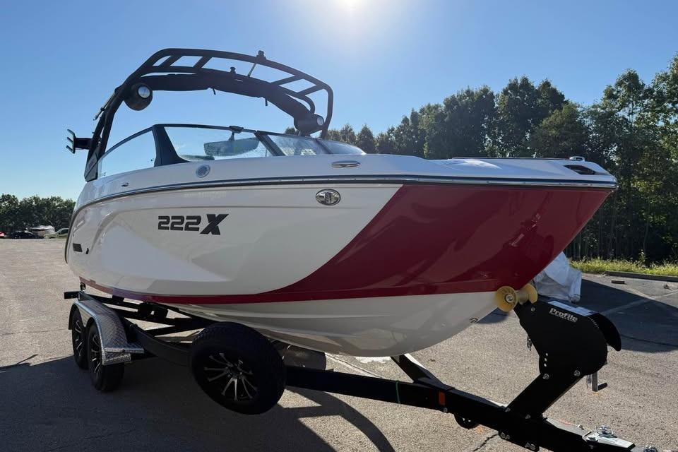 2026 Yamaha Boats 222XD on trailer, sleek design, red and white color scheme.