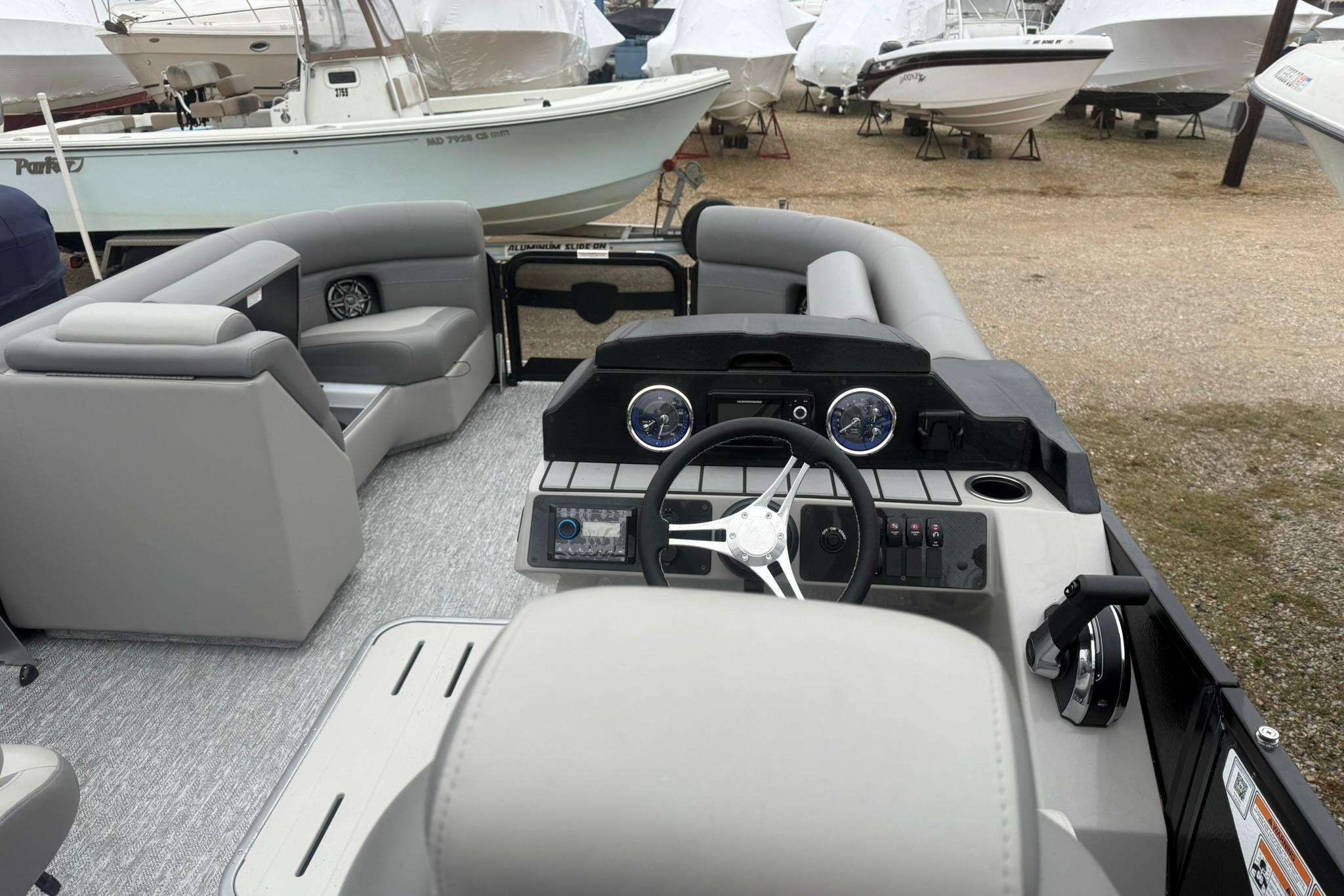 2026 Premier 210 Sunsation RL Tritoon interior with modern helm and seating.