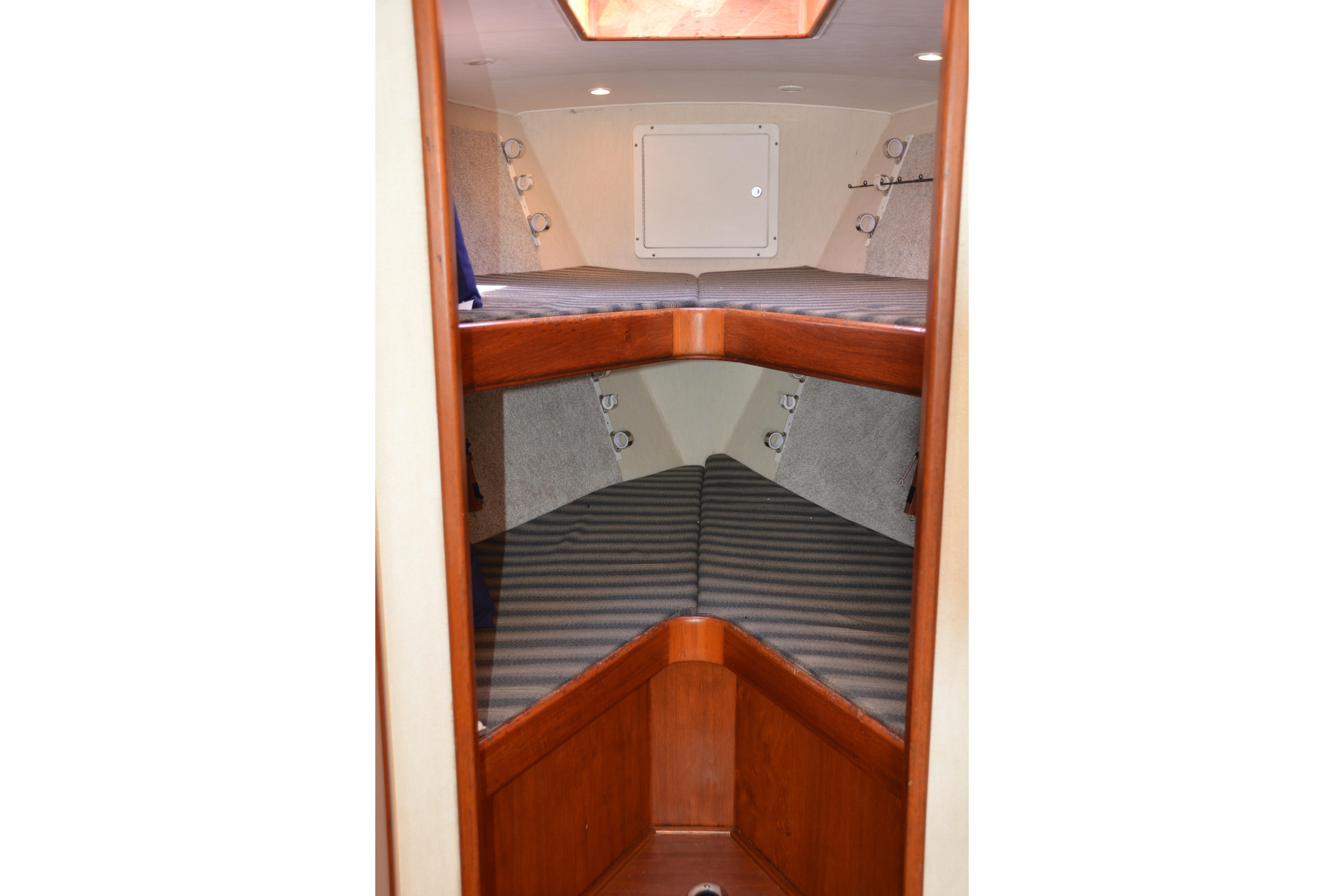 2006 Custom Carolina Heritage Express boat interior with wooden bunk beds.