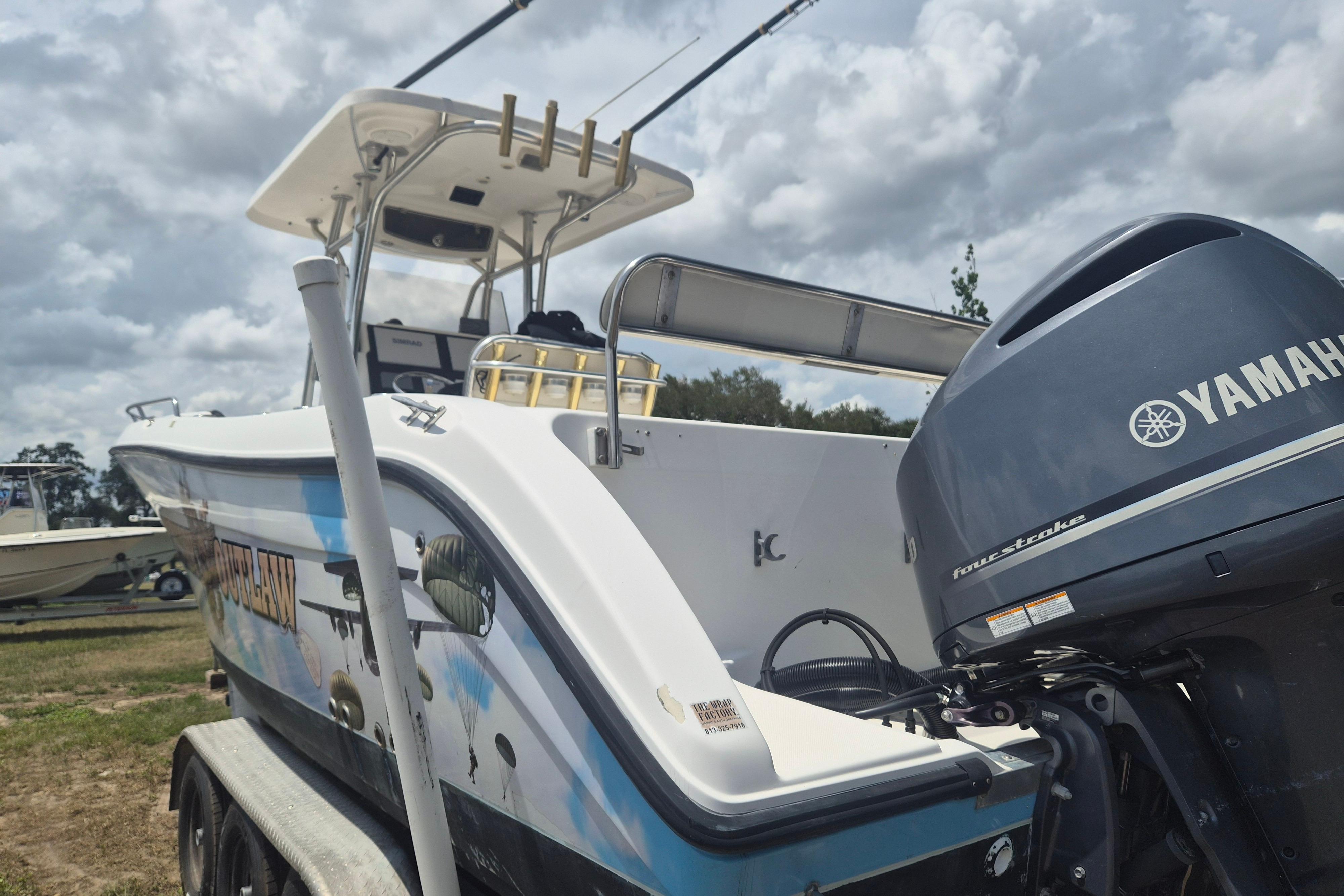 2006 Century 2900 Center Console boat with Yamaha outboard motor, parked outdoors.