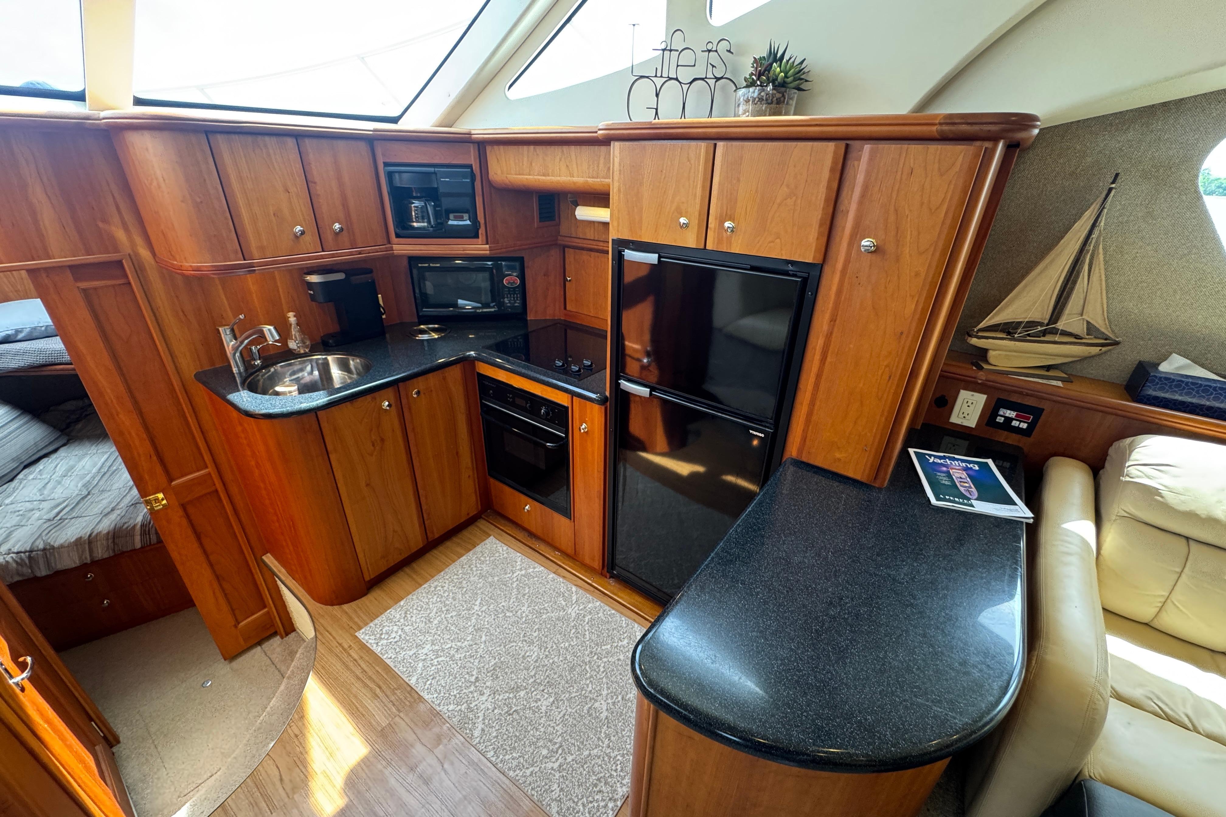 Interior of 2003 Silverton 39 Motor Yacht with wood cabinetry and modern kitchen amenities.