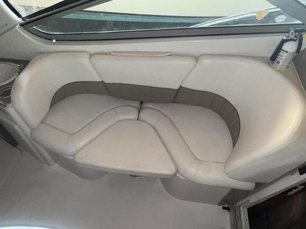 2005 Four Winns 298 Vista boat interior with beige seating and a fire extinguisher.