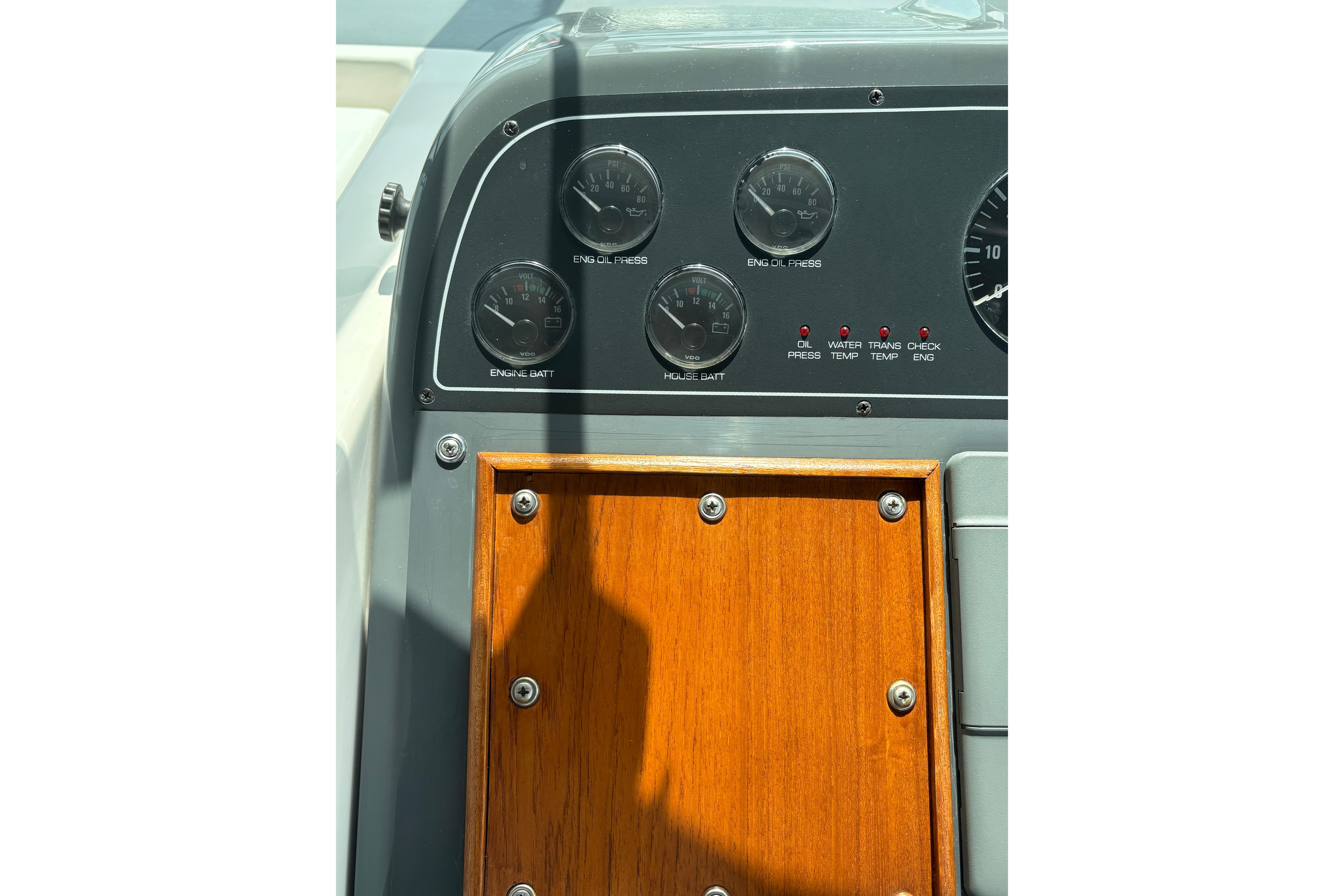 Dashboard of a 1999 Tiara Yachts 3100 Open, featuring gauges and wooden panel.