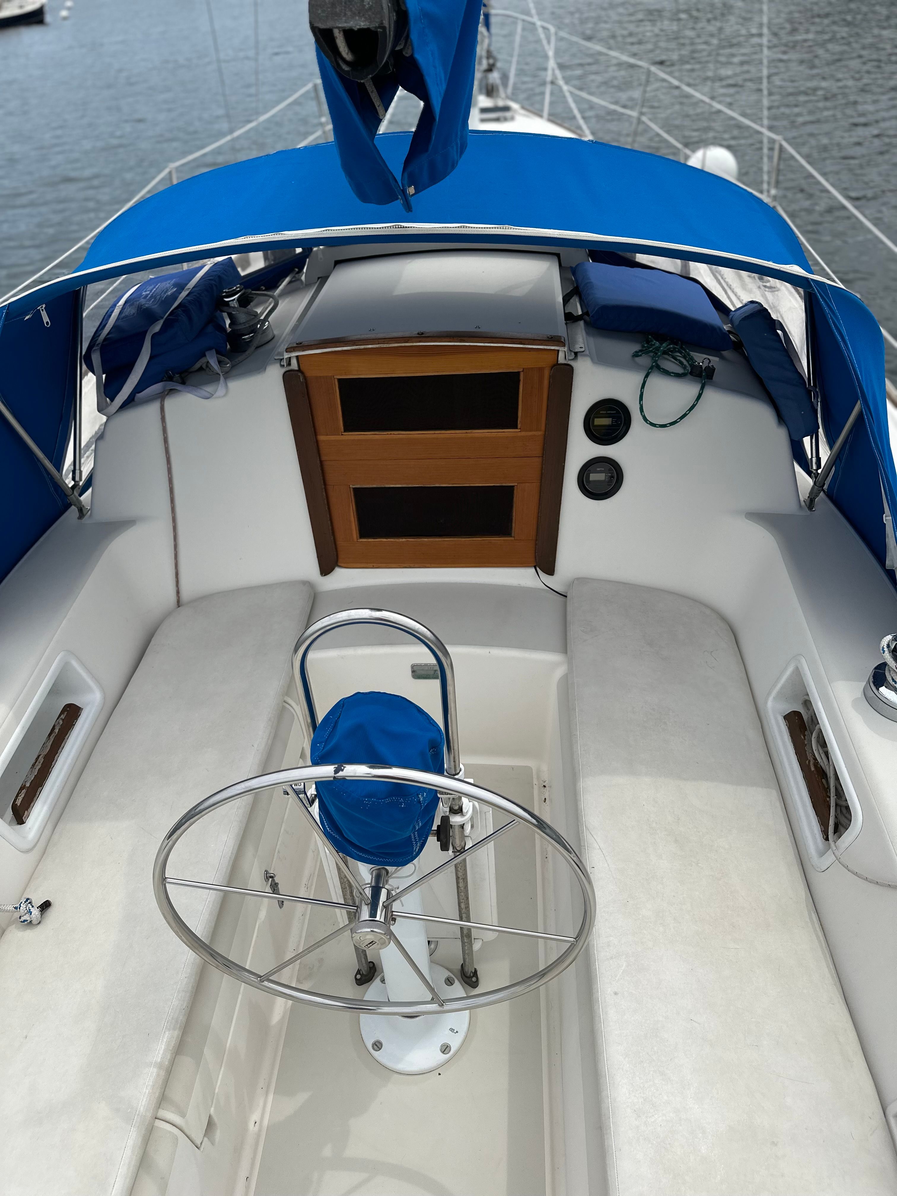 The image shows the cockpit of a 1984 Pearson 303 with blue covers.