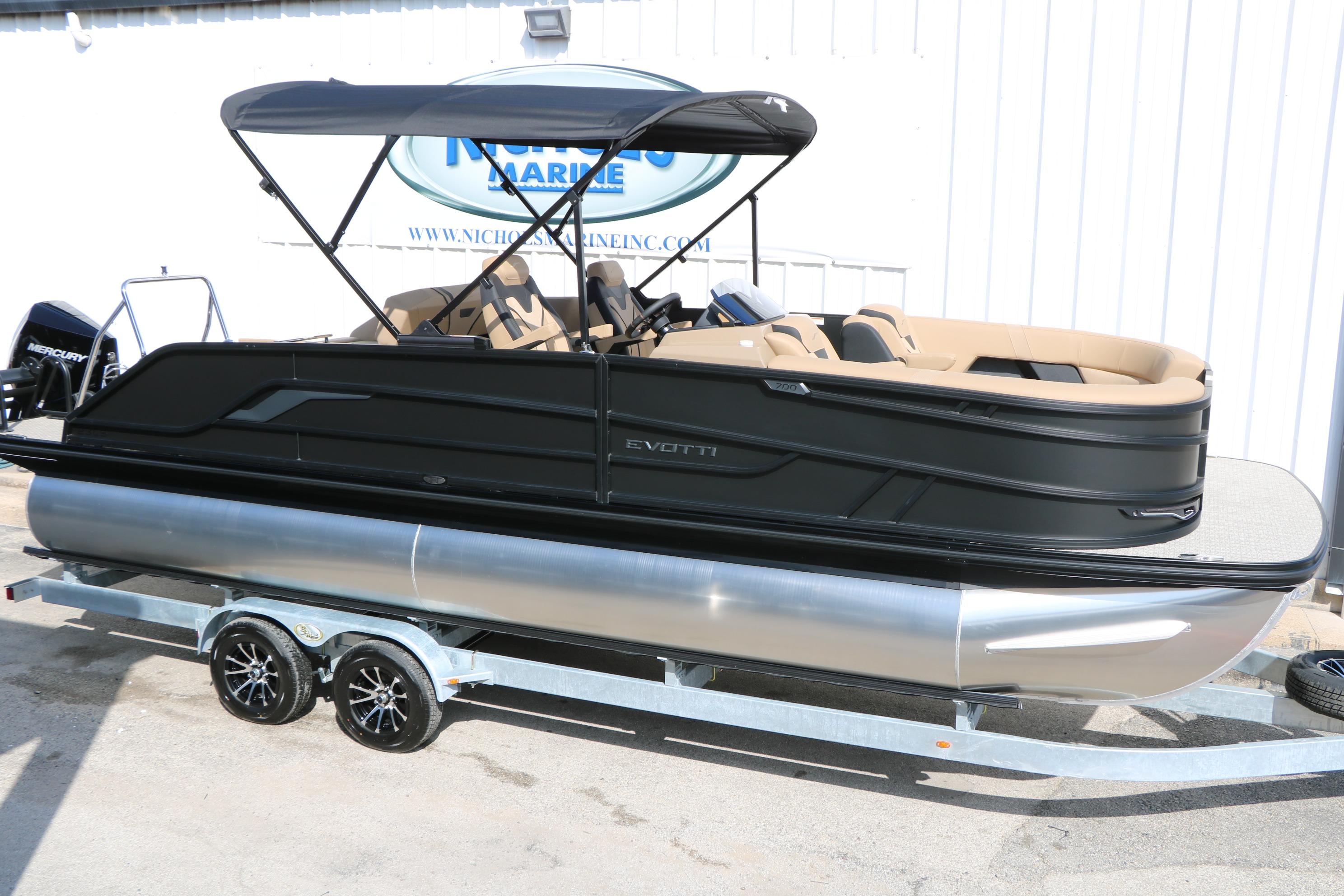 2026 Evotti 723CS pontoon boat on trailer, black exterior, beige interior, under canopy.