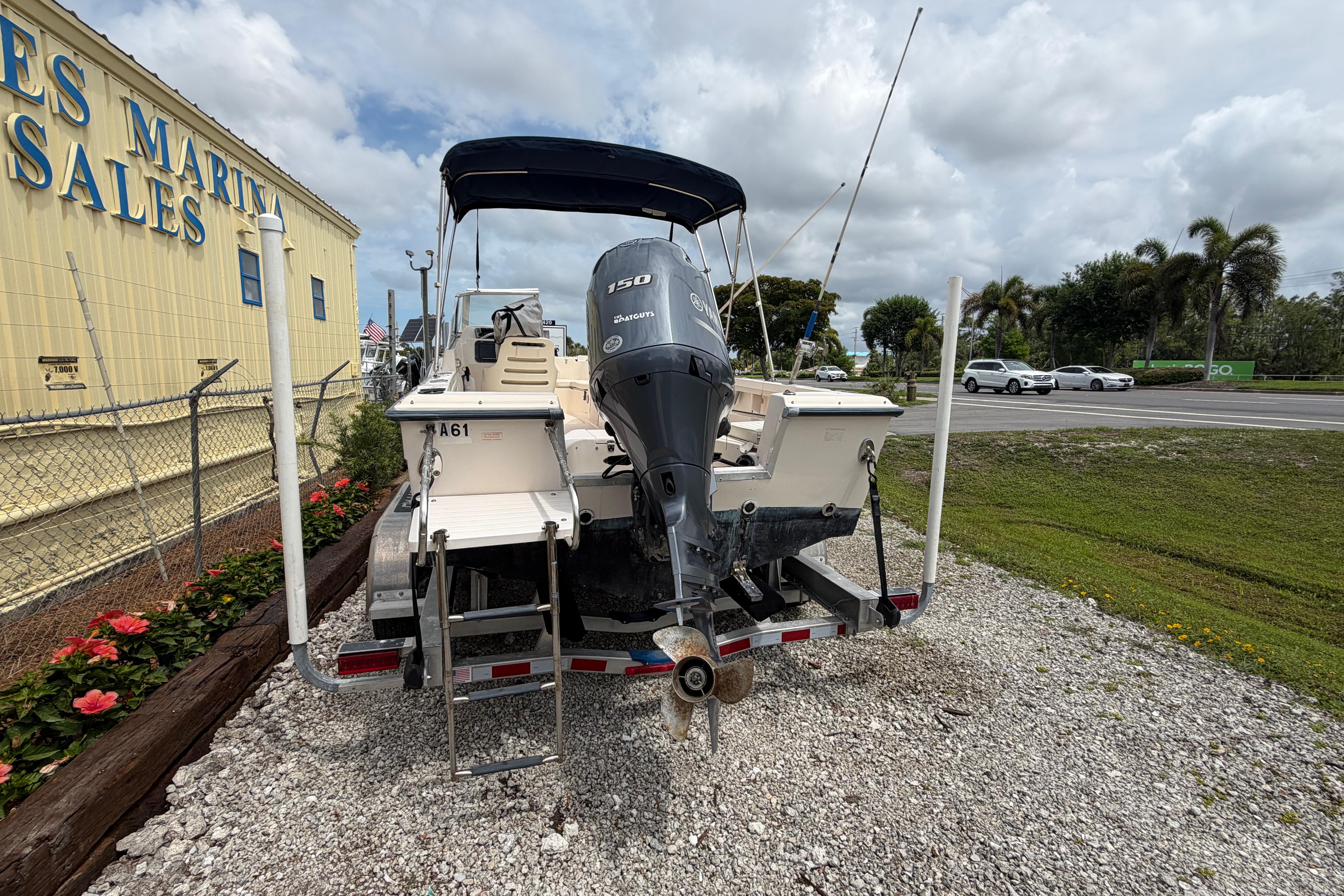 2006 Grady-White Tournament 185 boat with outboard motor at marina sales lot.