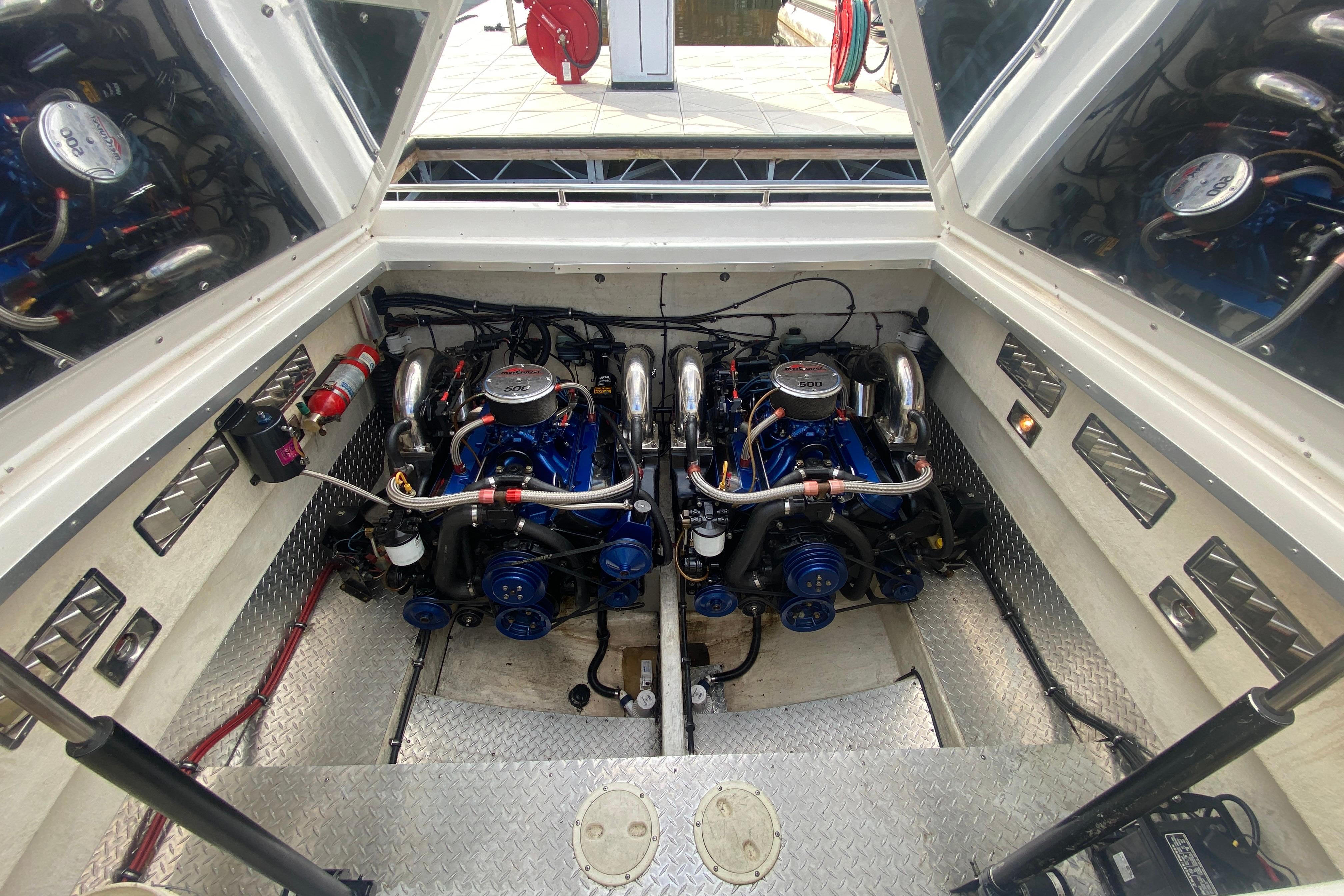 Engine compartment of a 1999 Black Thunder XT 430 SC boat, showcasing dual engines.