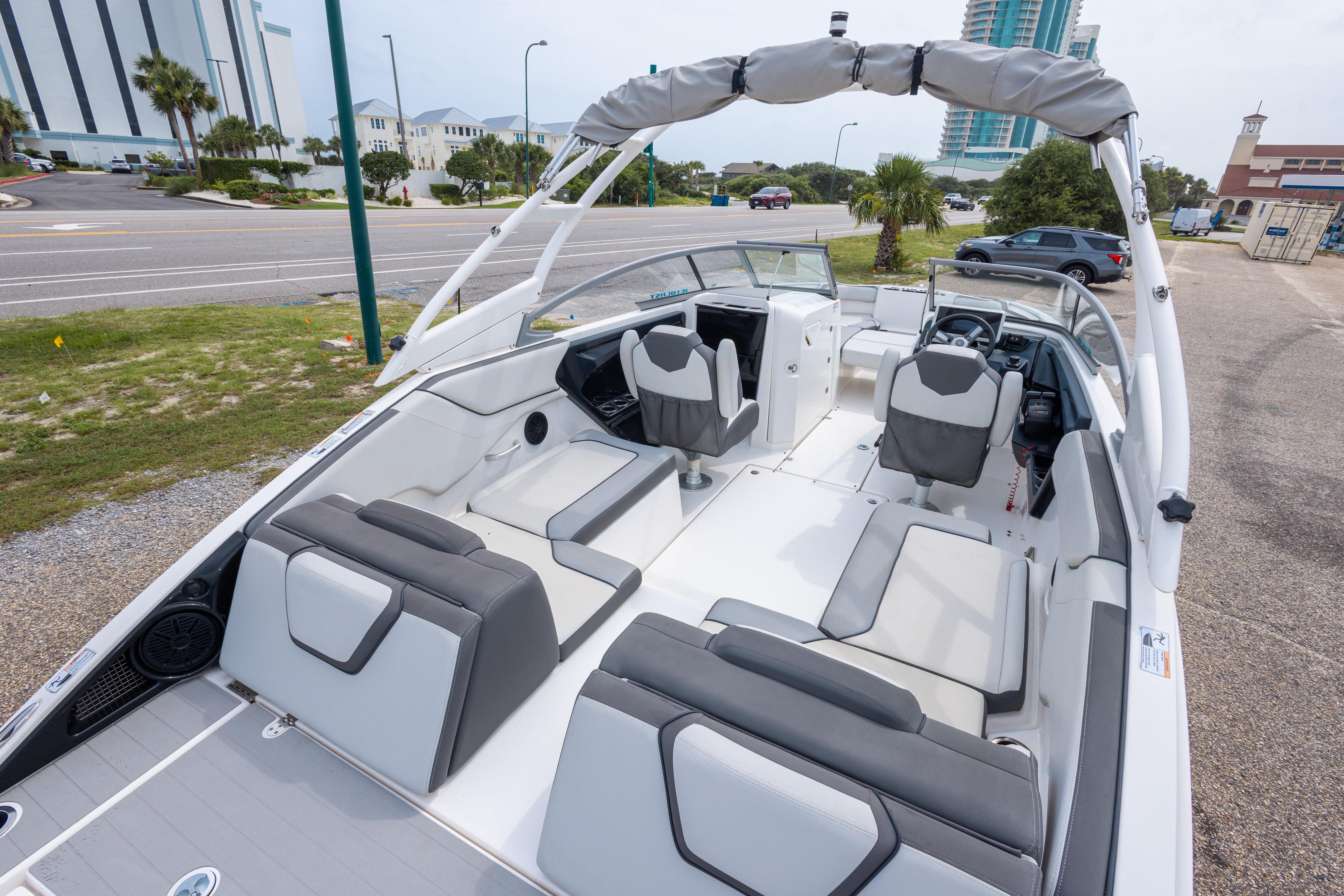 2021 Yamaha Boats AR250 interior with sleek seating and modern design, parked near a road.