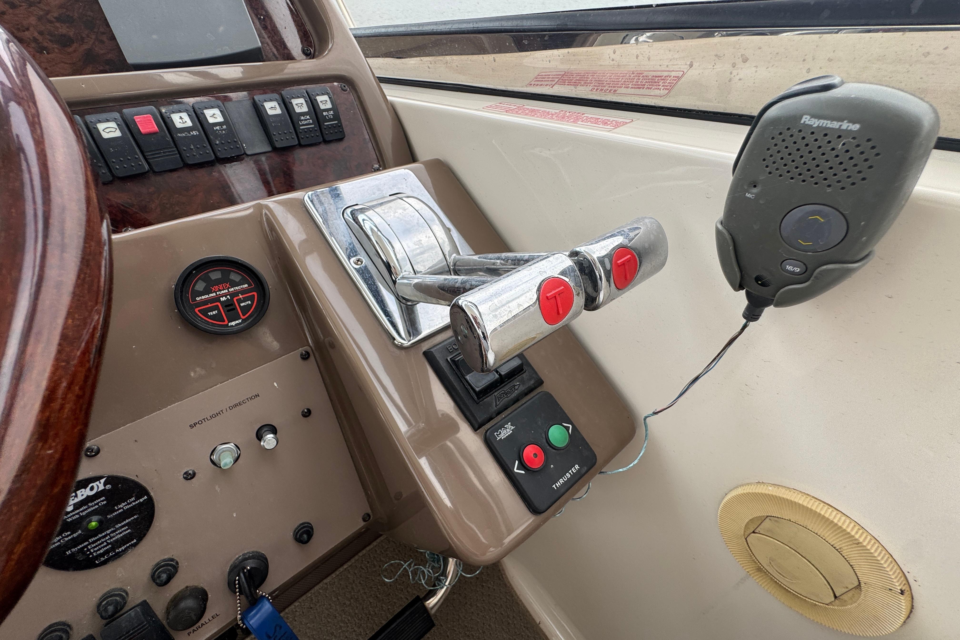 Control panel of a 2005 Regal Commodore 4260 boat with throttle and communication device.