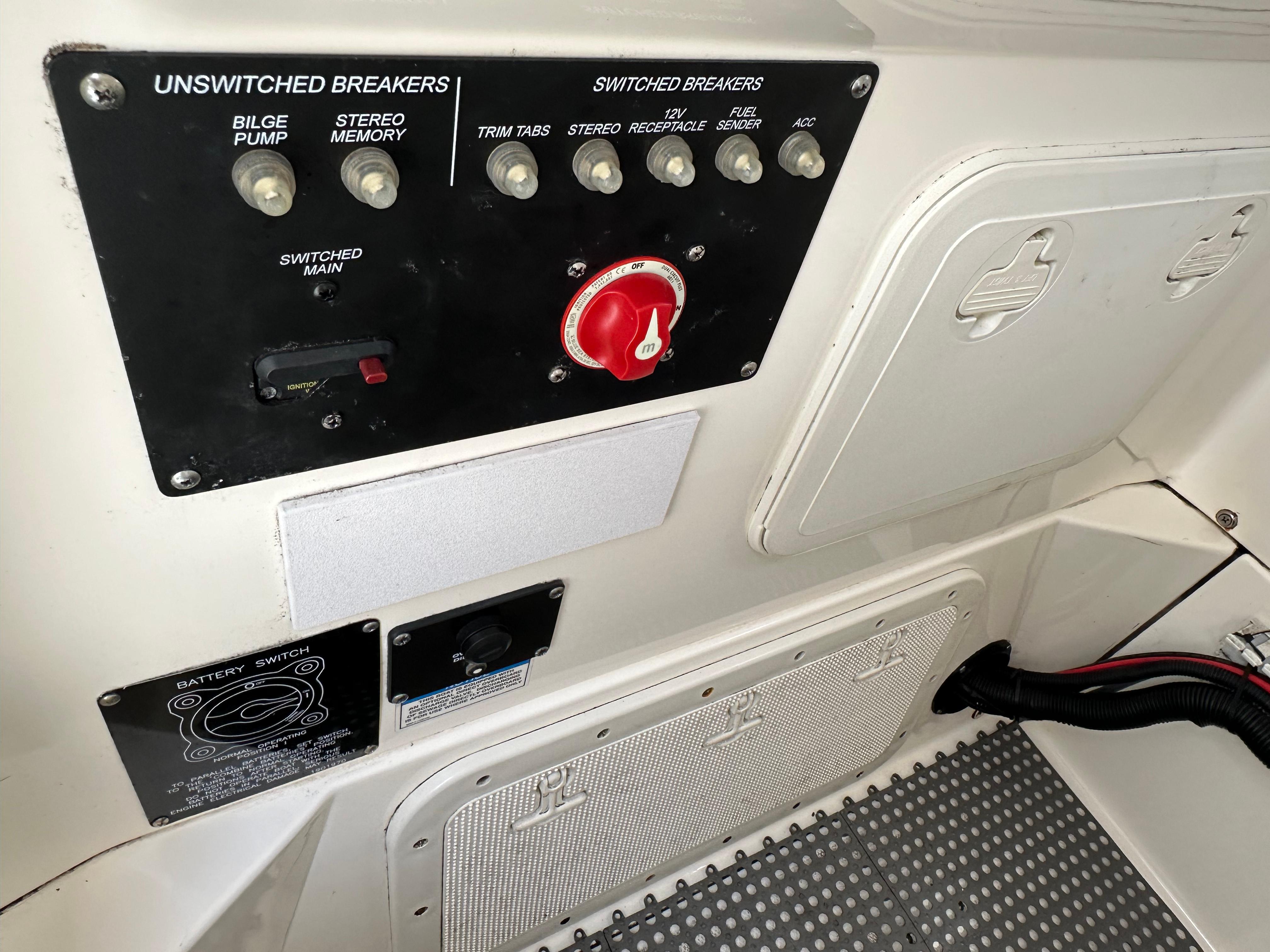 Control panel of a 2011 Boston Whaler 220 Outrage boat with switches and breakers.