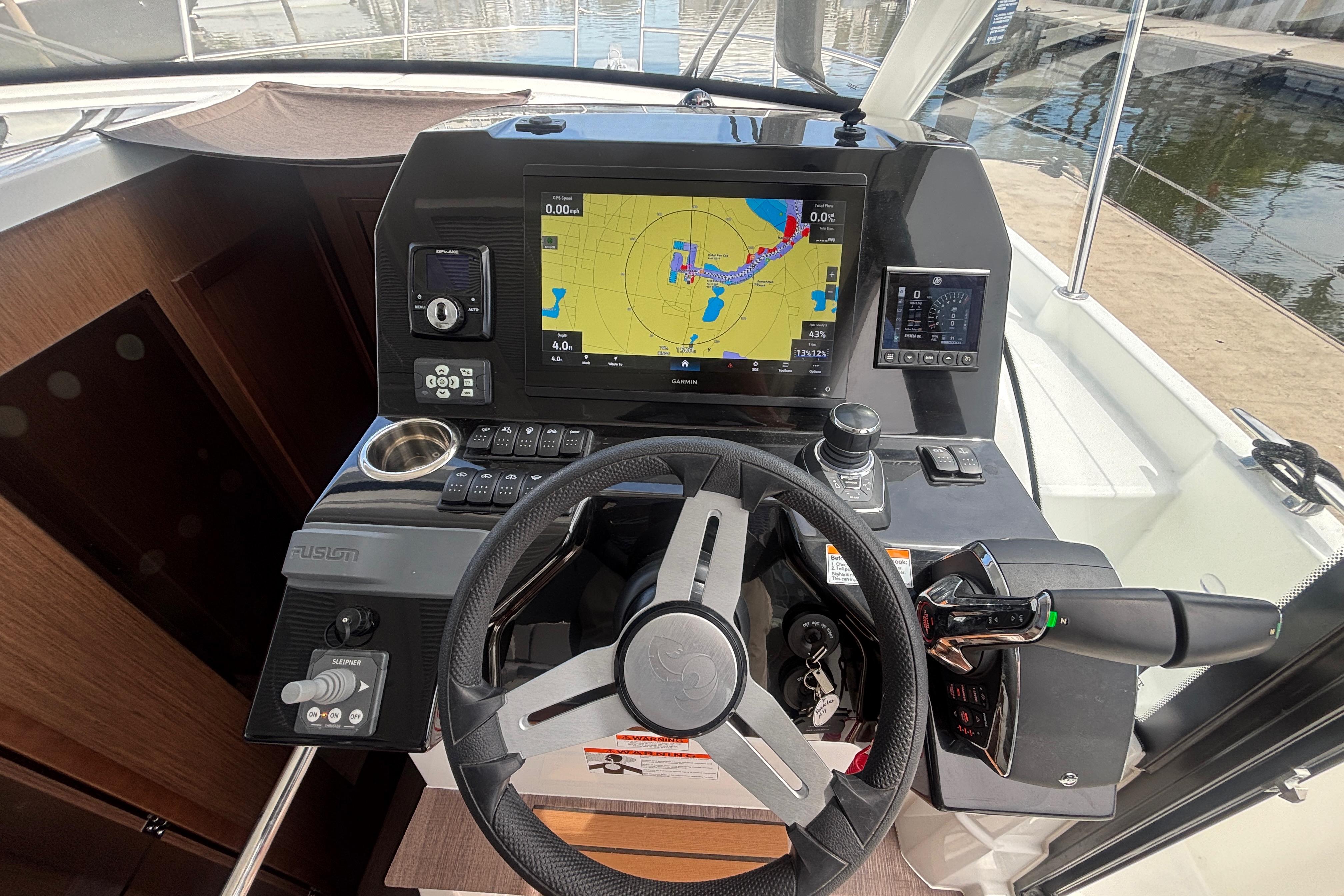 2024 Beneteau Antares 11 helm with navigation display and controls.