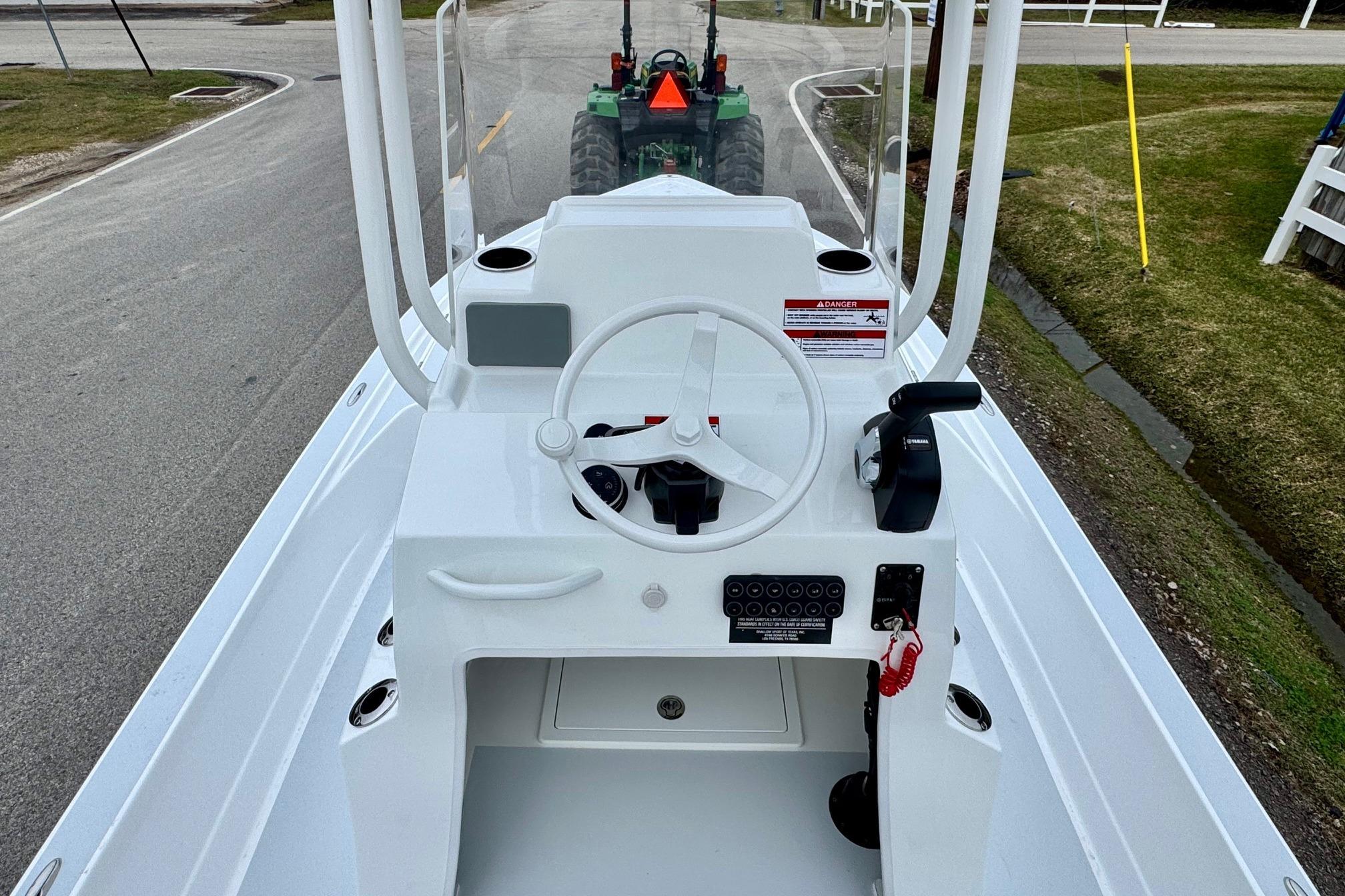 2026 Shallow Sport 24 Modified V boat console with steering wheel and controls.