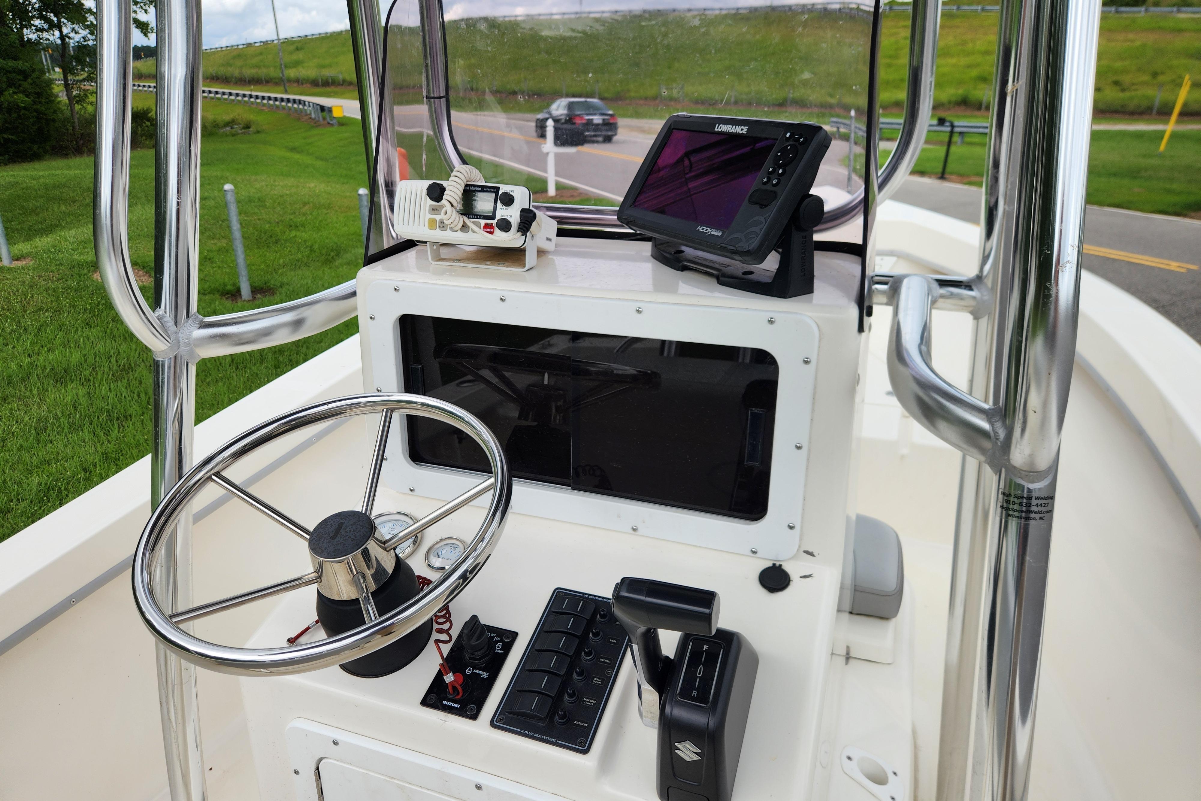 2023 May-Craft 1900CC boat console with steering wheel and navigation equipment.
