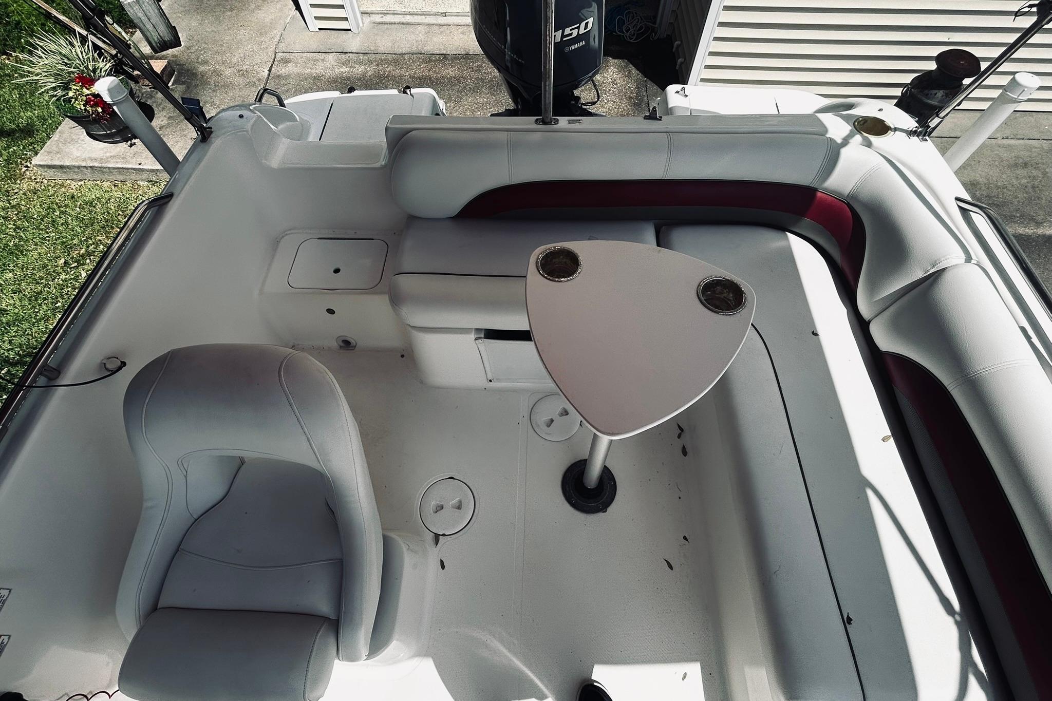 2013 Hurricane SunDeck Sport 201 OB boat interior with seating and table.