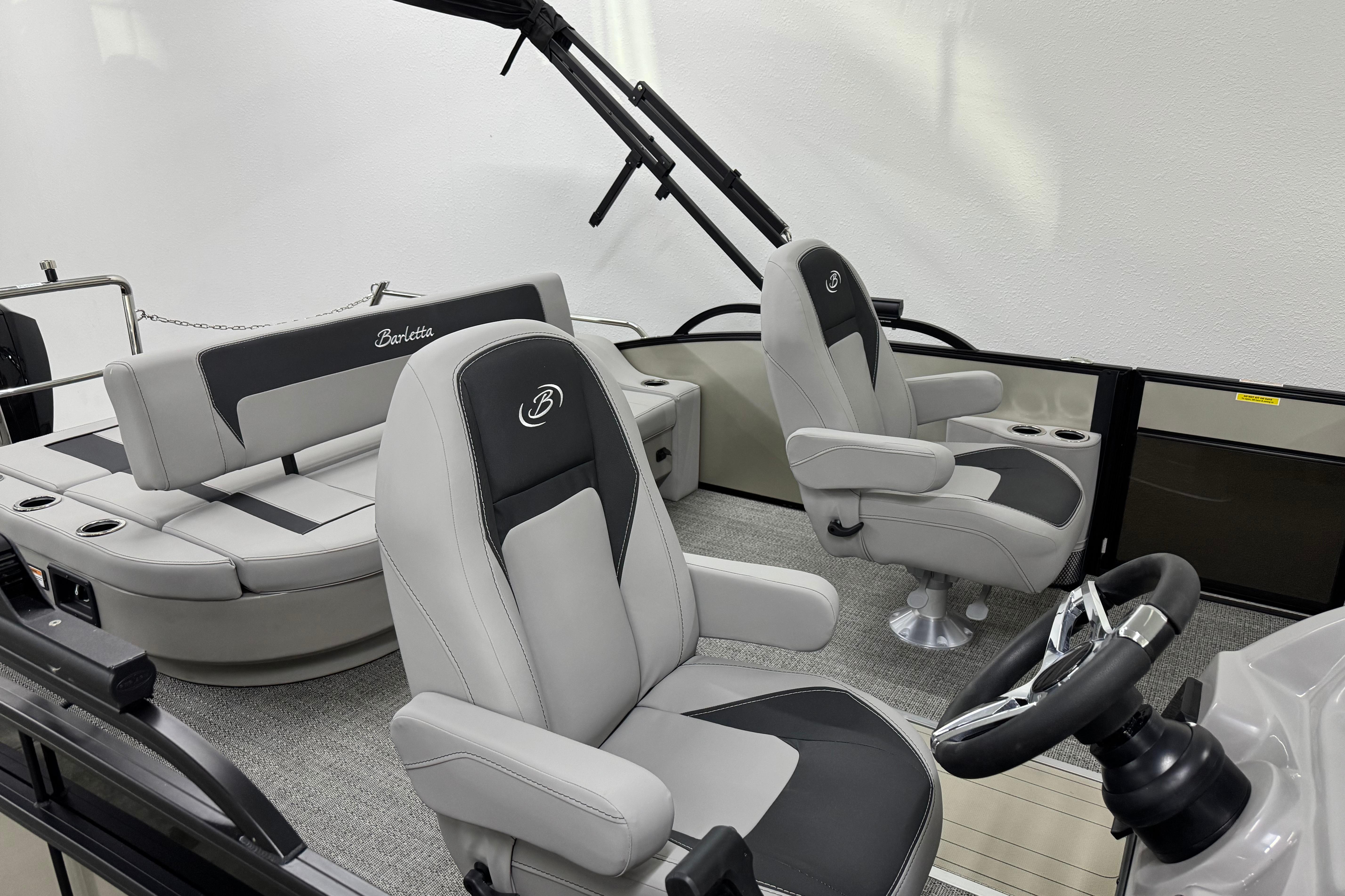 2025 Barletta Aria 24UC boat interior with plush seating and modern steering wheel.