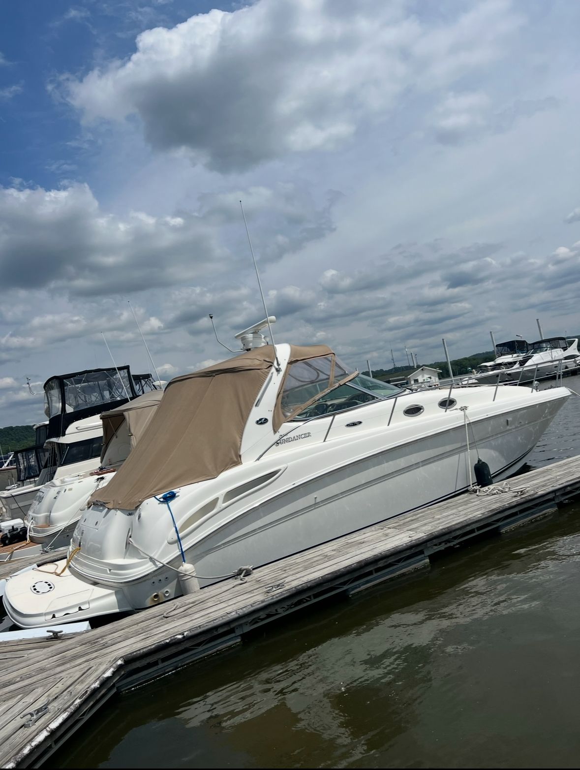 2002 Sea Ray 360 Sundancer docked under cloudy sky.