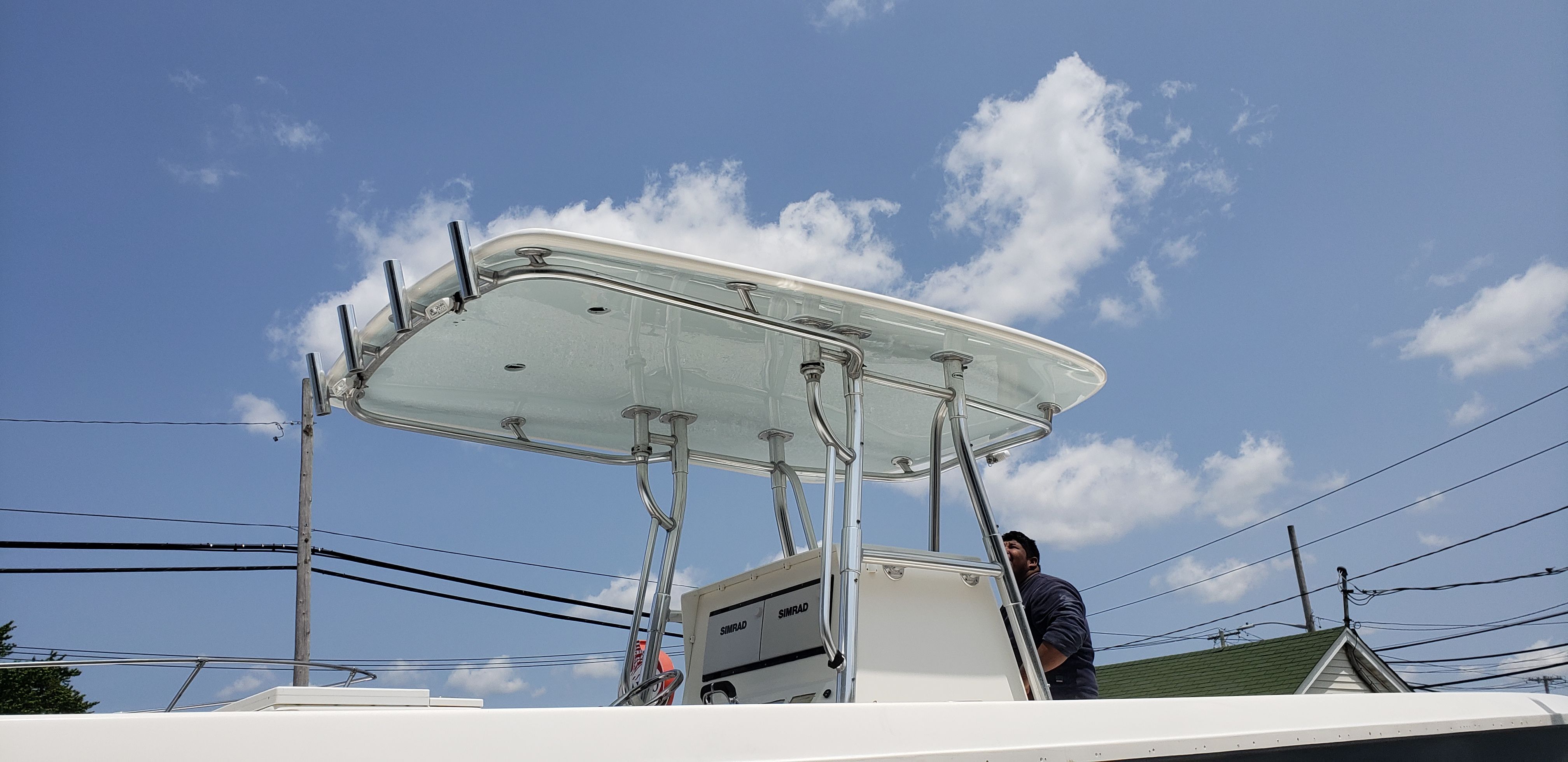 Contender 33 Tournament 2009 boat with T-top under blue sky.