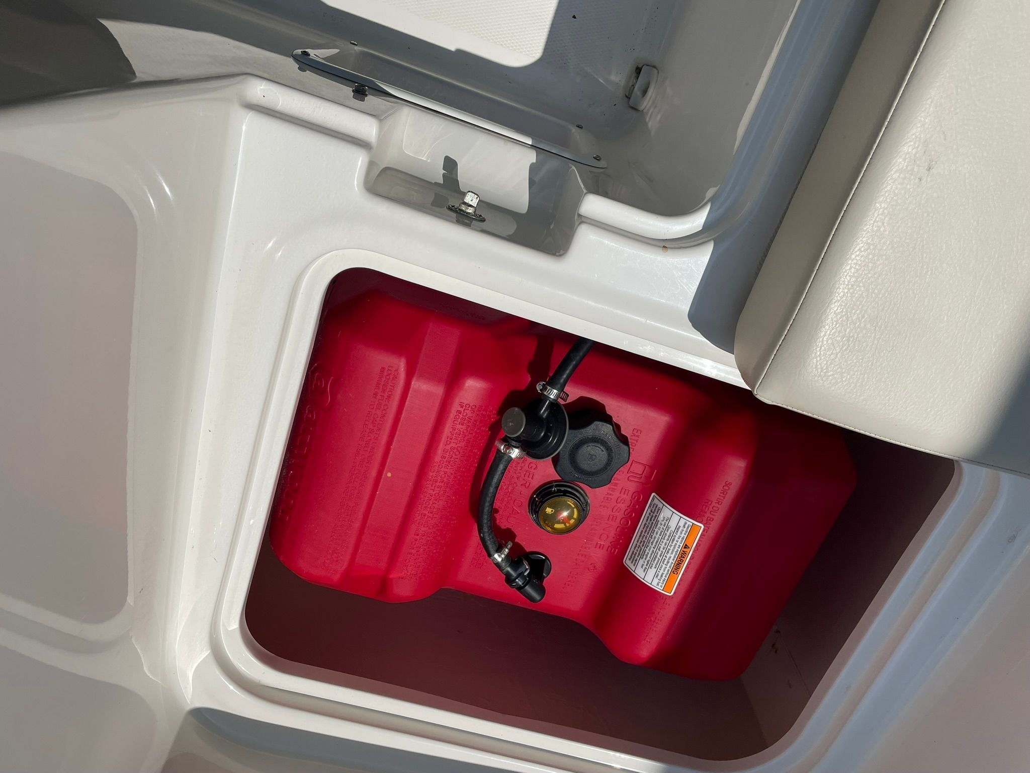 A red fuel tank is visible in a storage compartment of a 2018 Bayliner 160 Bowrider.