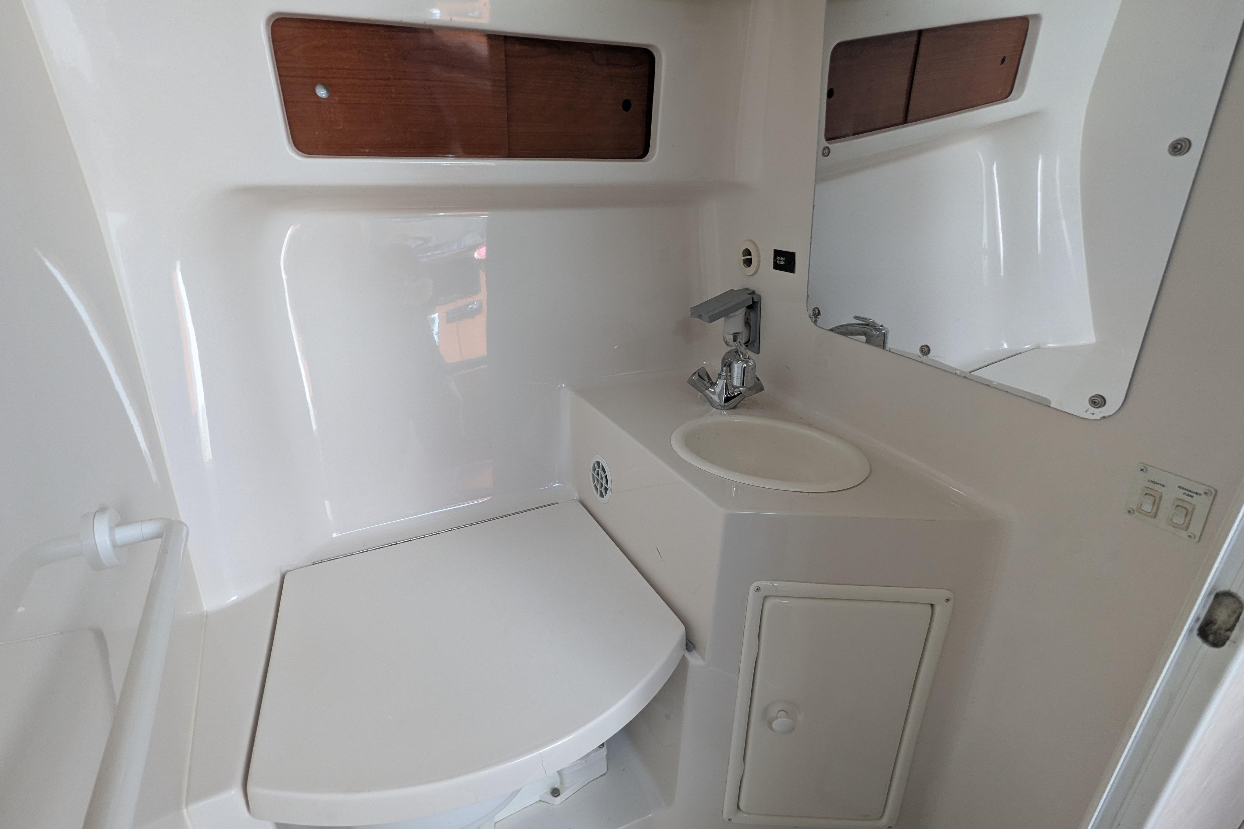 2003 Monterey 282 Cruiser bathroom with sink, mirror, and storage cabinet.
