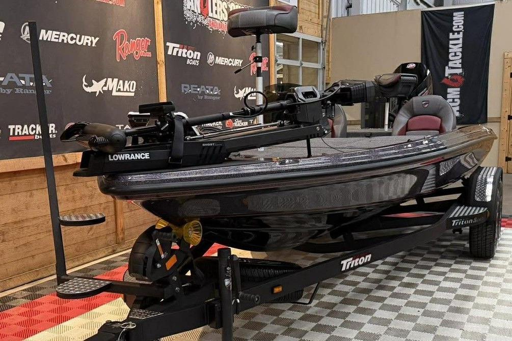 2026 Triton 20XP Patriot boat on display with Lowrance equipment.