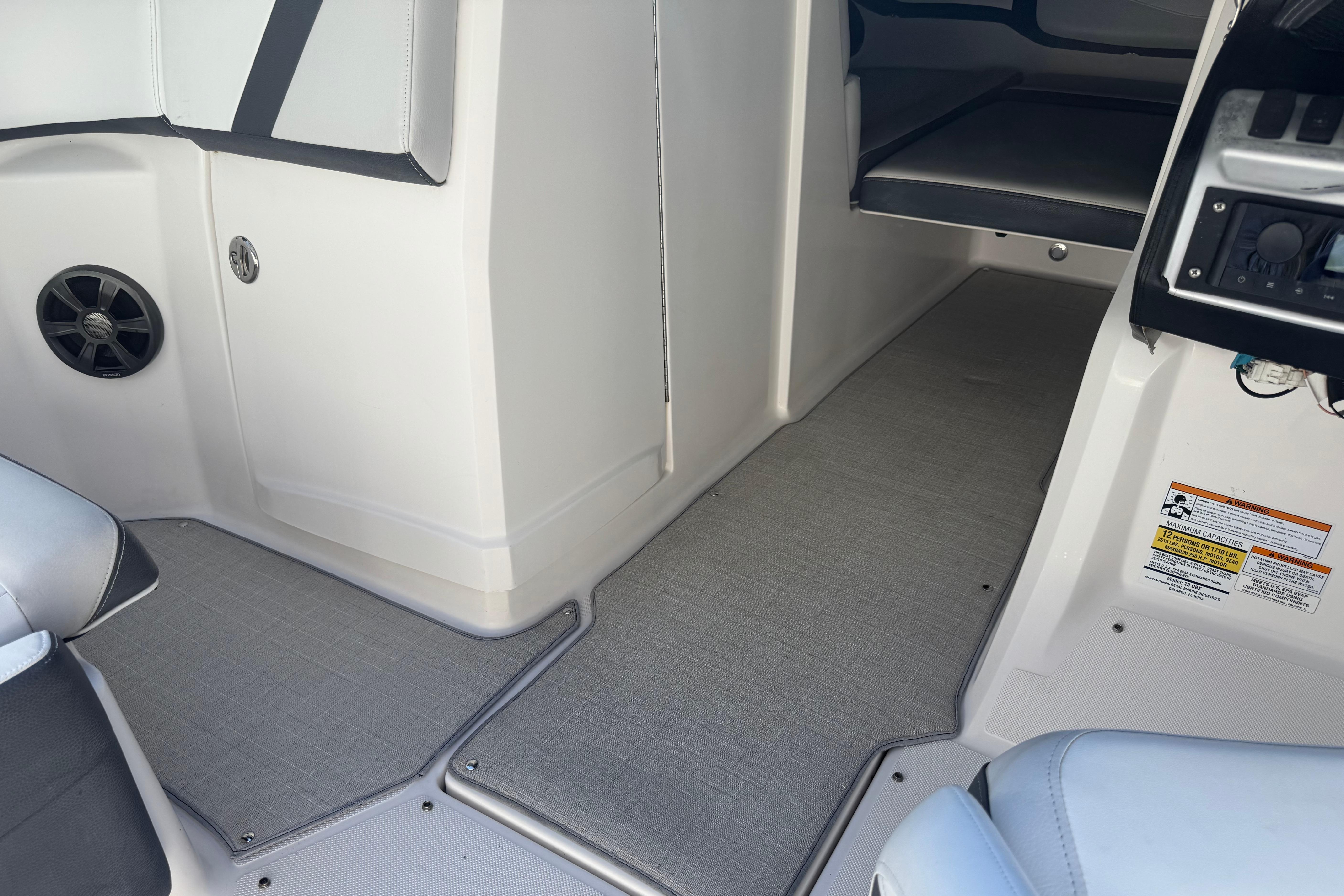 Interior view of a 2017 Regal 23 OBX boat, featuring seating and speaker details.
