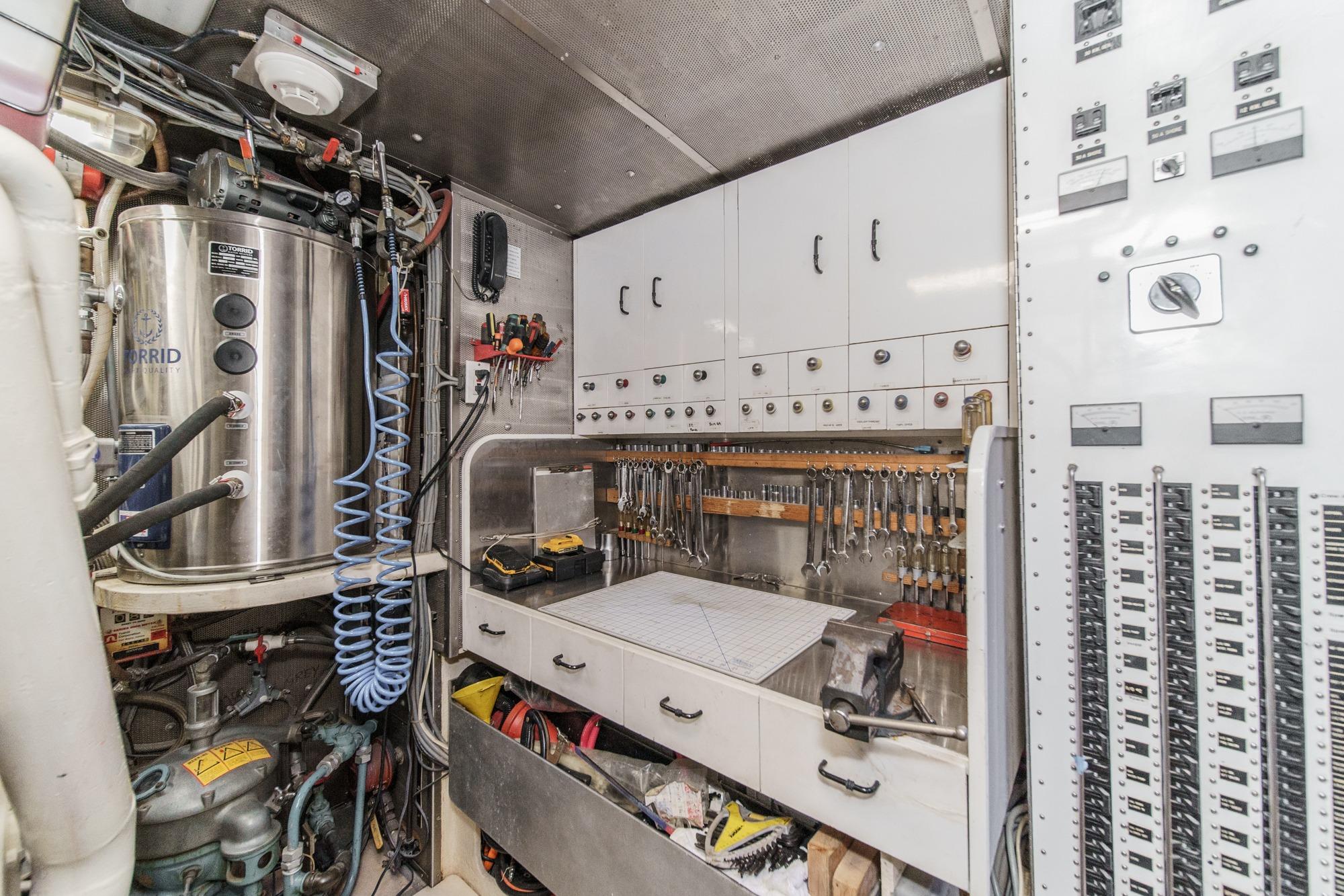 Engine room of a 1990 Seaton Long Range Cruiser with tools and control panels.