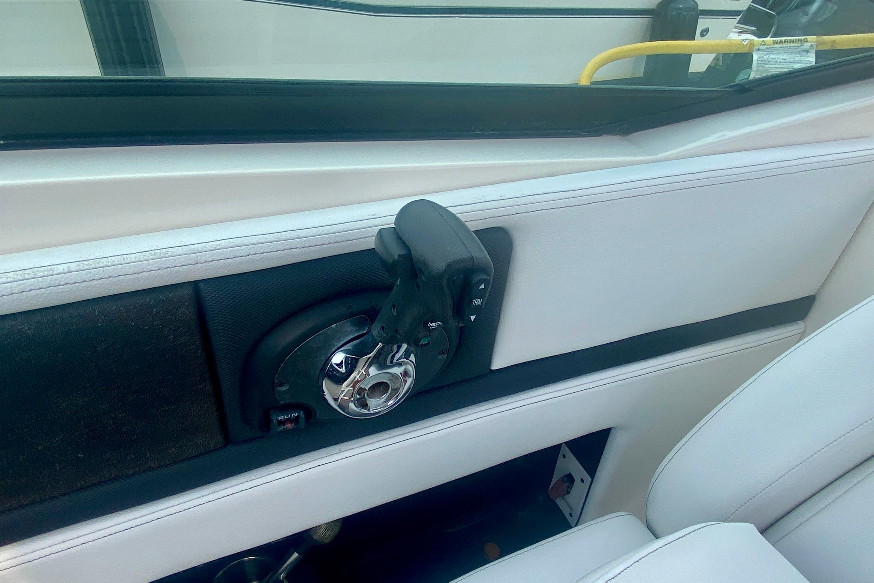 Interior view of a 2015 Sea Ray 250 SLX boat throttle control.