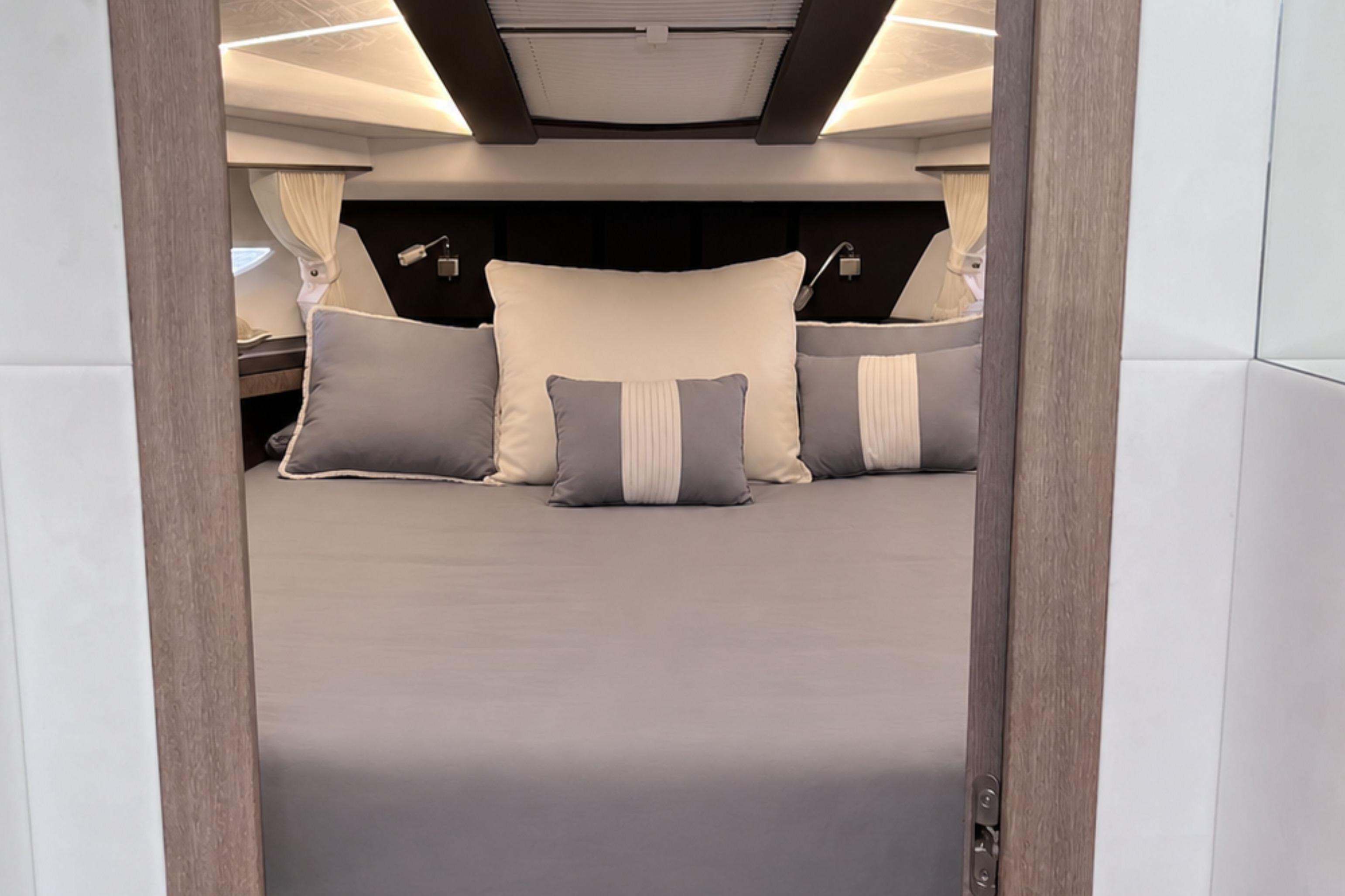 Luxurious bedroom interior of 2024 Galeon 425 HTS yacht with elegant bedding.