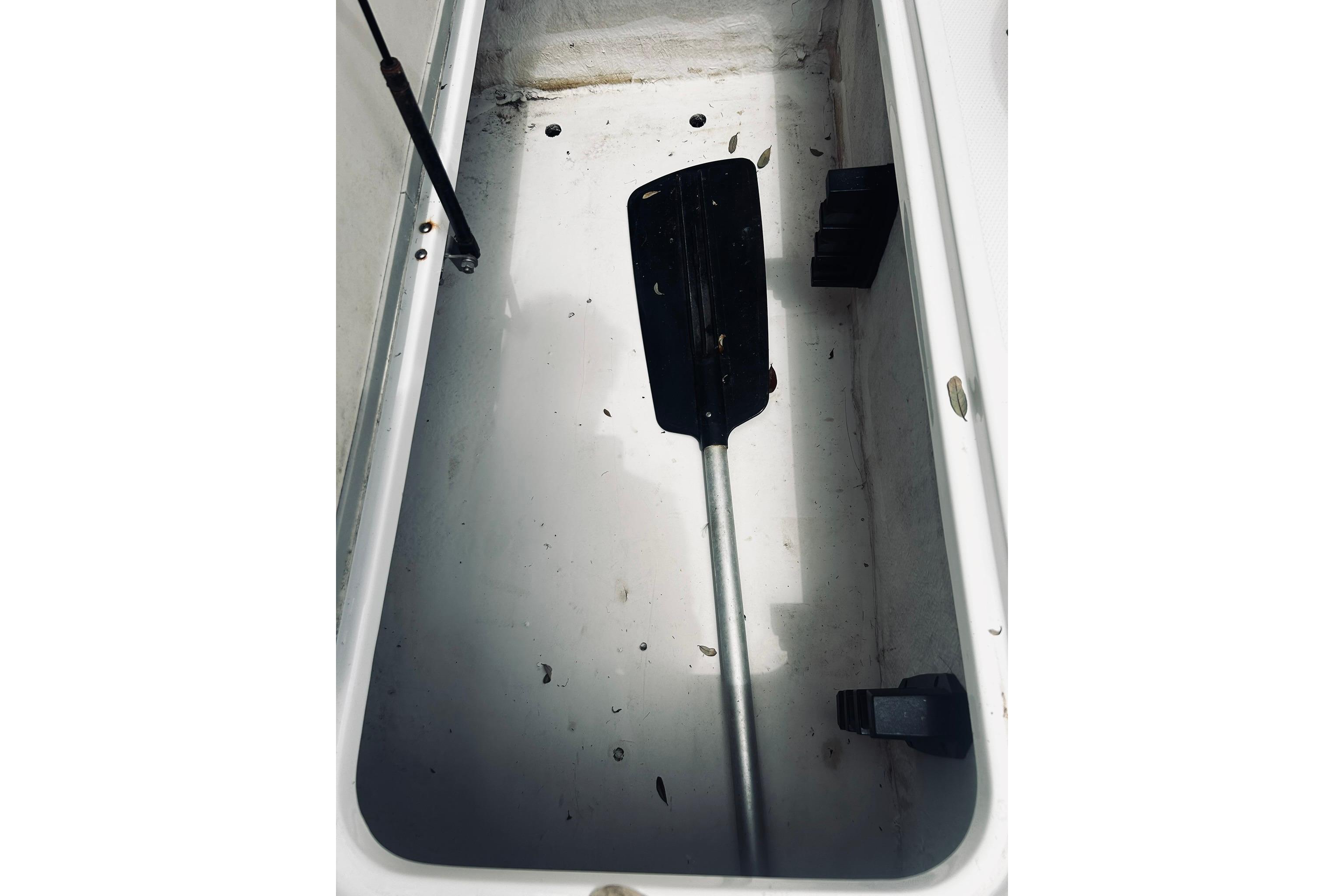 Storage compartment with paddle in 2013 Hurricane SunDeck Sport 201 OB boat.