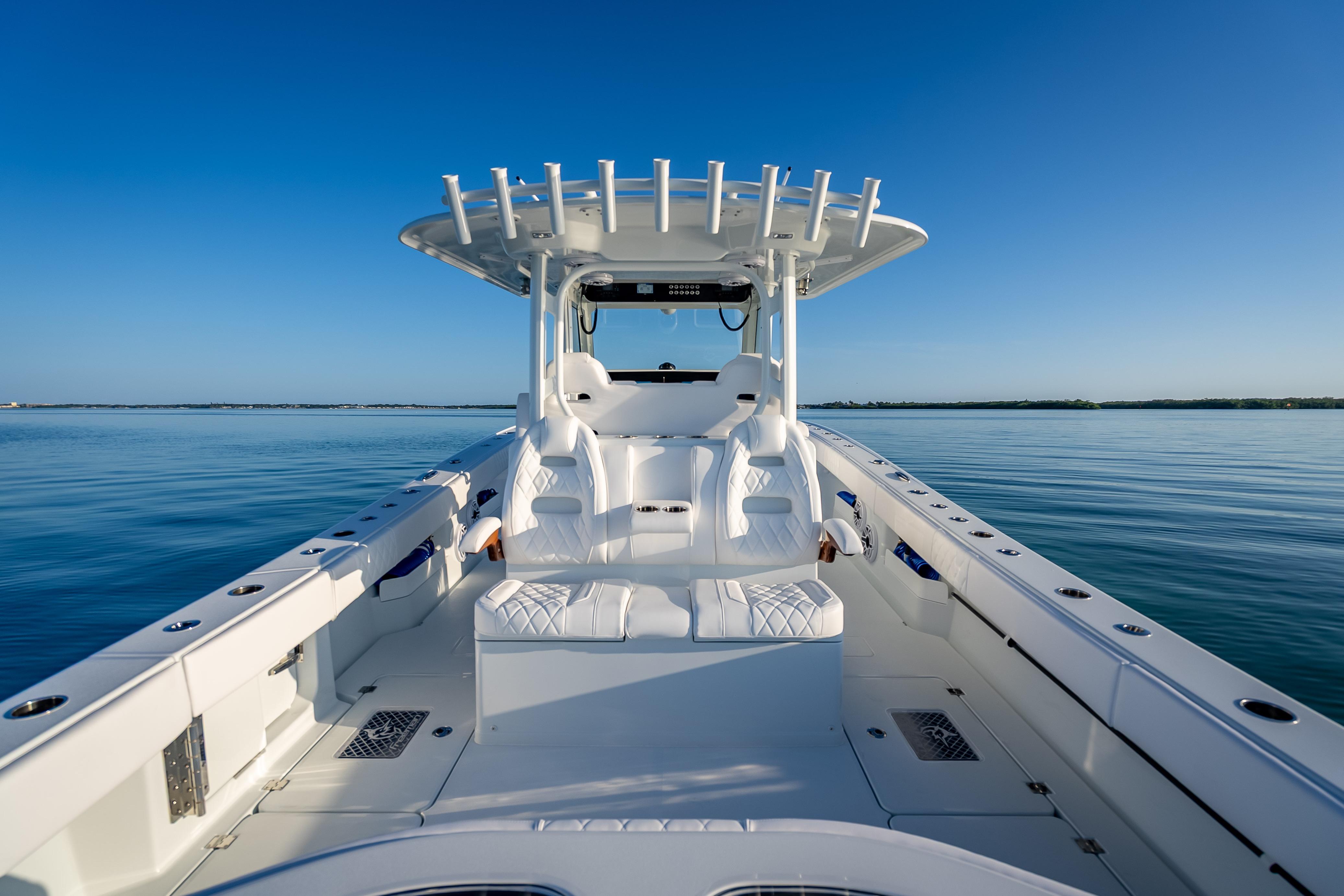 2026 Freeman 35 boat on calm water, featuring sleek white seating and modern design.