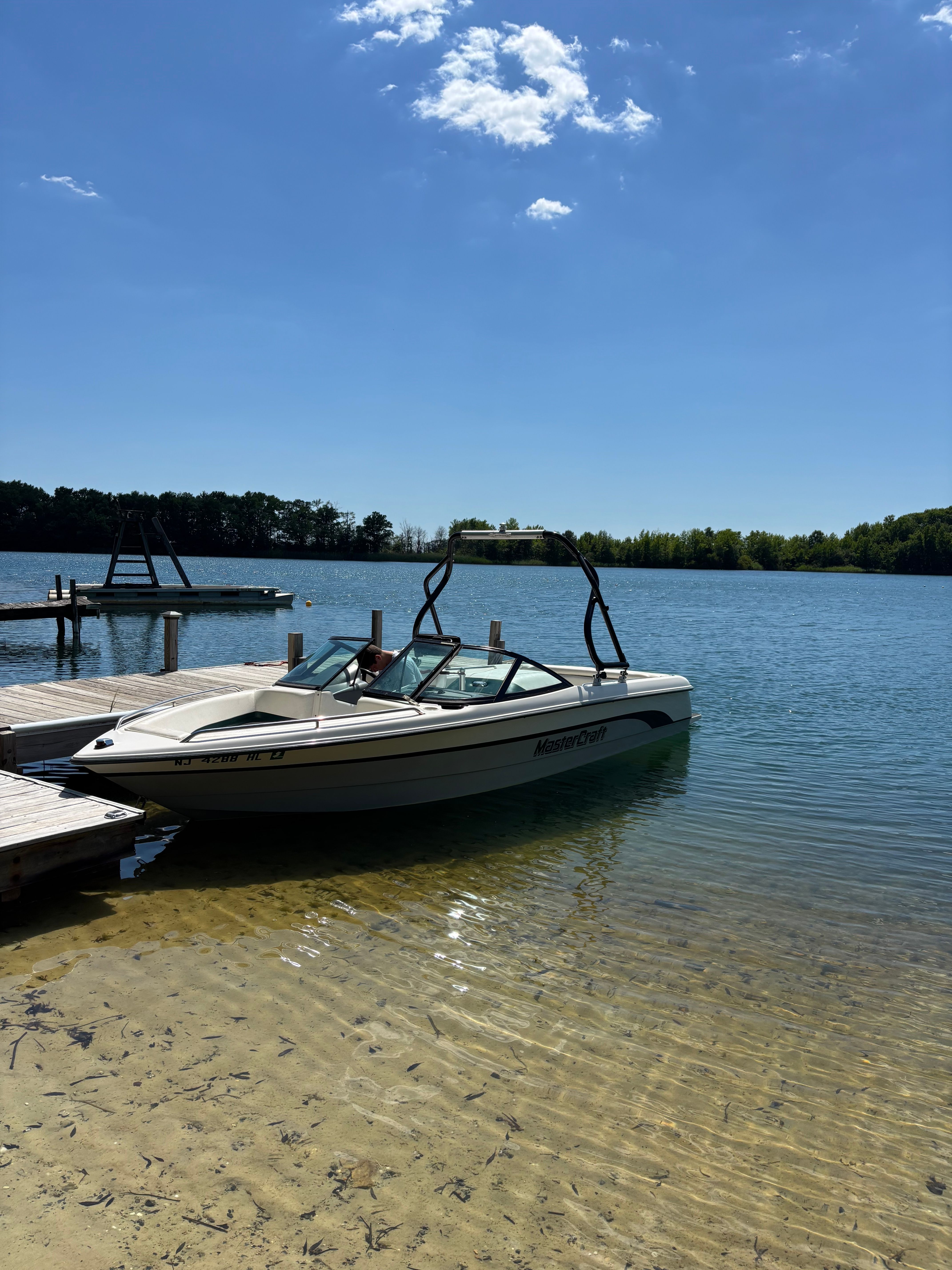 1997 MasterCraft Prostar 205 boat docked at lakeside.