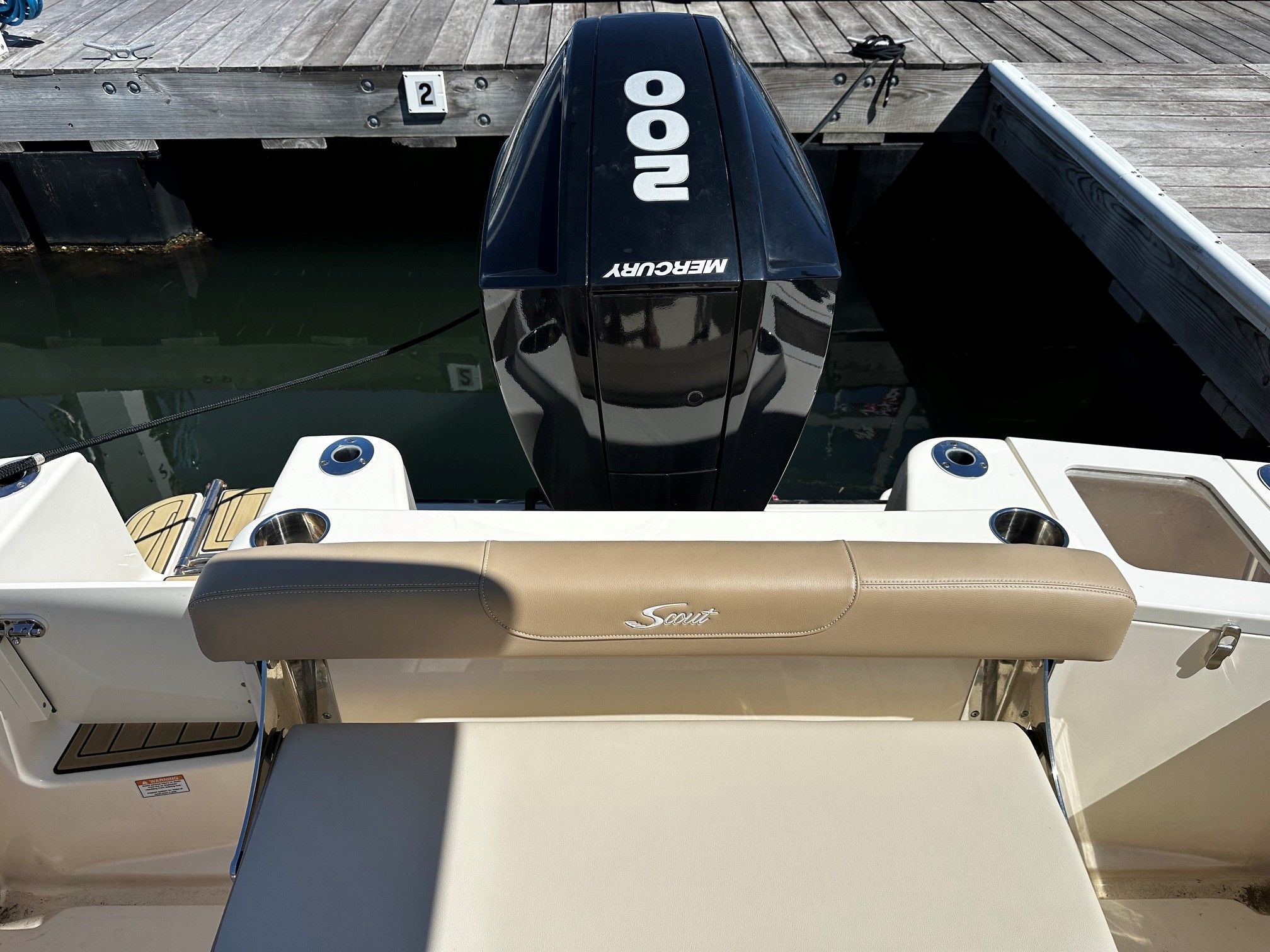Scout 210XSF boat at dock with Mercury engine.