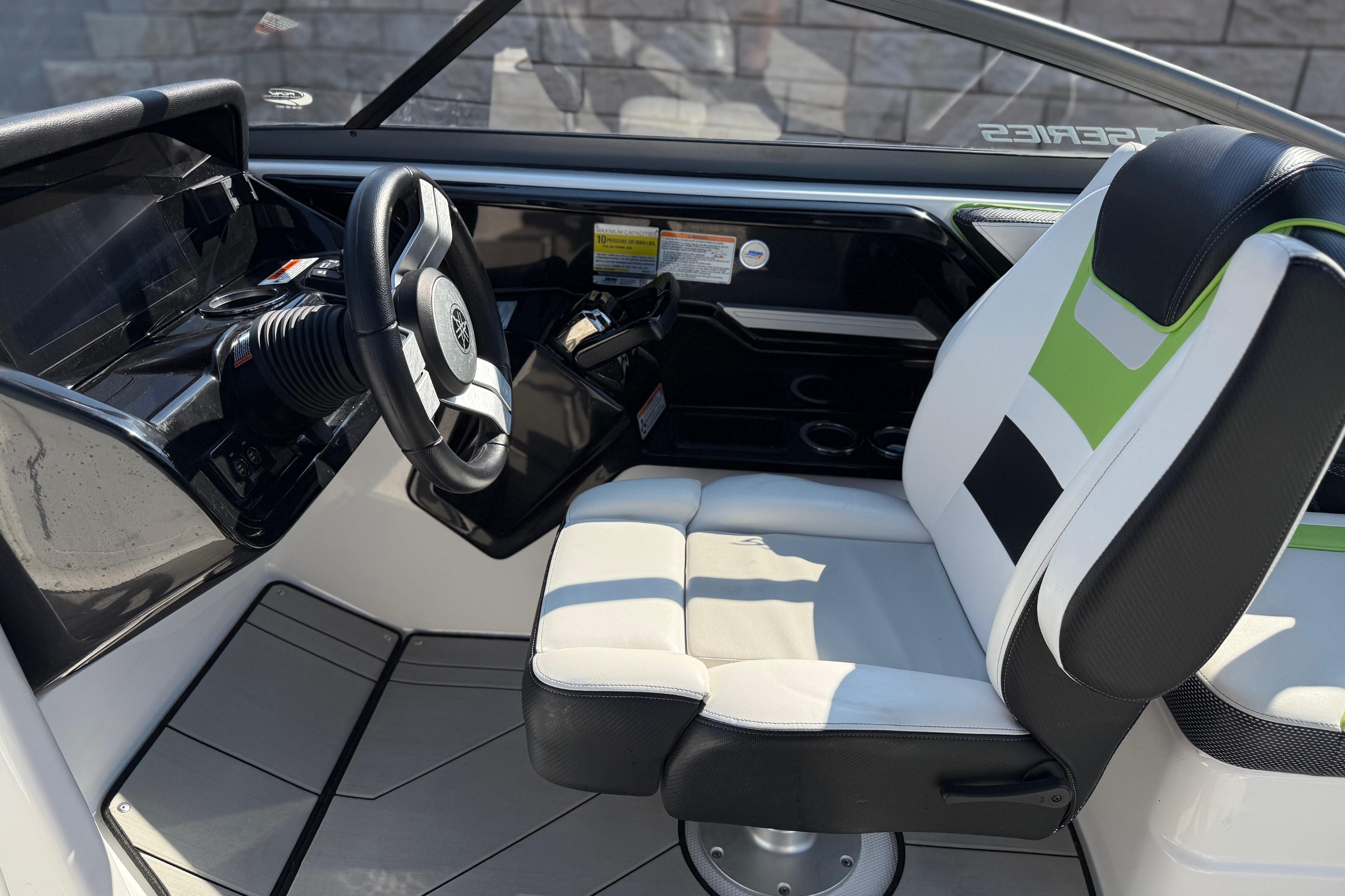 Interior of 2022 Yamaha Boats 212XE, featuring sleek steering and modern seating design.
