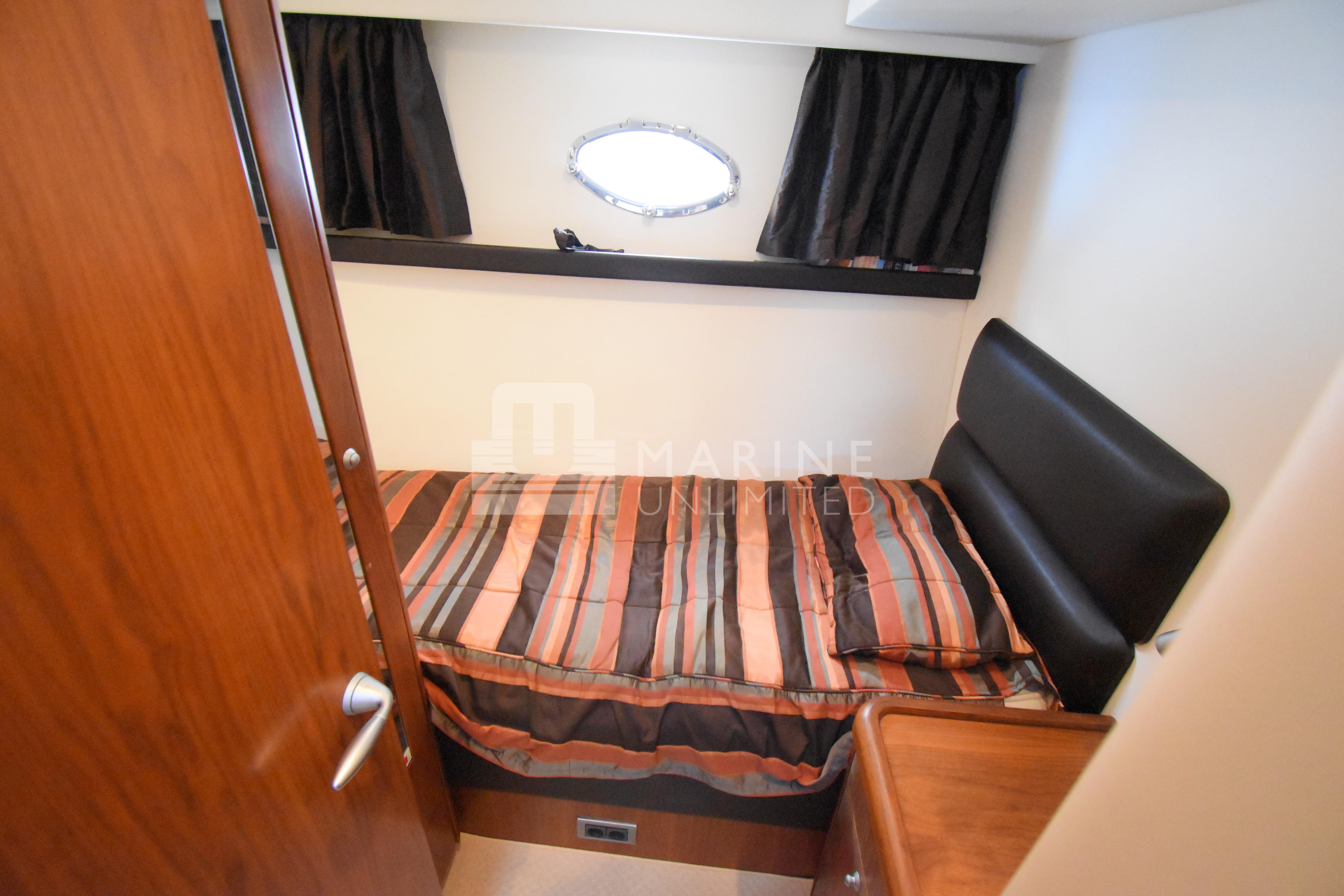 Cabin interior of 2010 Sunseeker Manhattan 52 yacht with striped bedding.