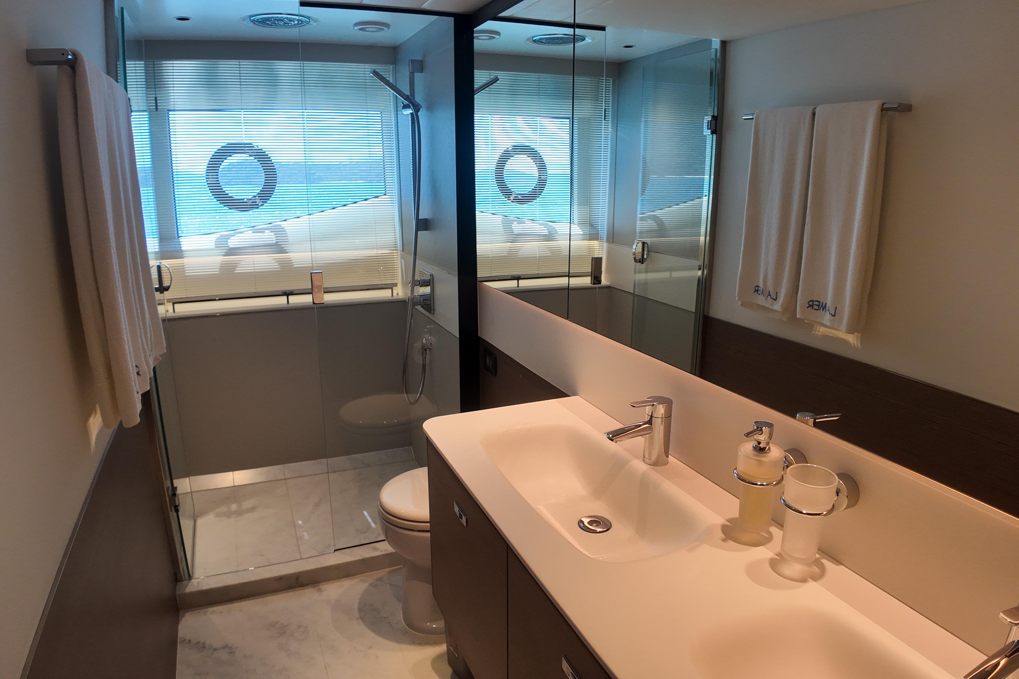 Luxurious bathroom in 2023 Princess Y72 yacht with modern fixtures and ocean view.