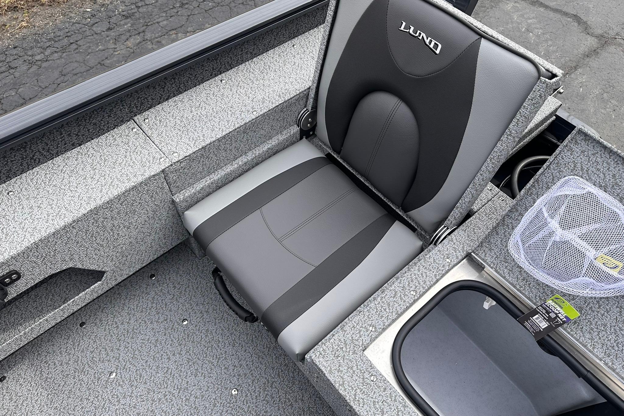 2026 Lund 1775 Adventure Sport boat seat with gray upholstery and storage compartments.