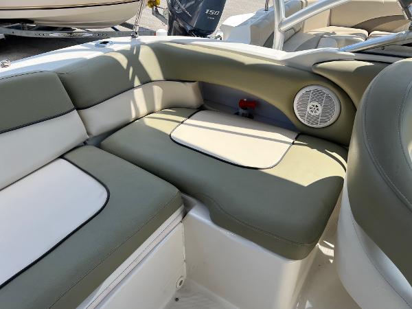 2005 Sea Ray 220 Sundeck interior with cushioned seating and speaker.