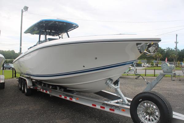 2024 Fountain 34 SC boat on trailer, sleek design, parked outdoors.