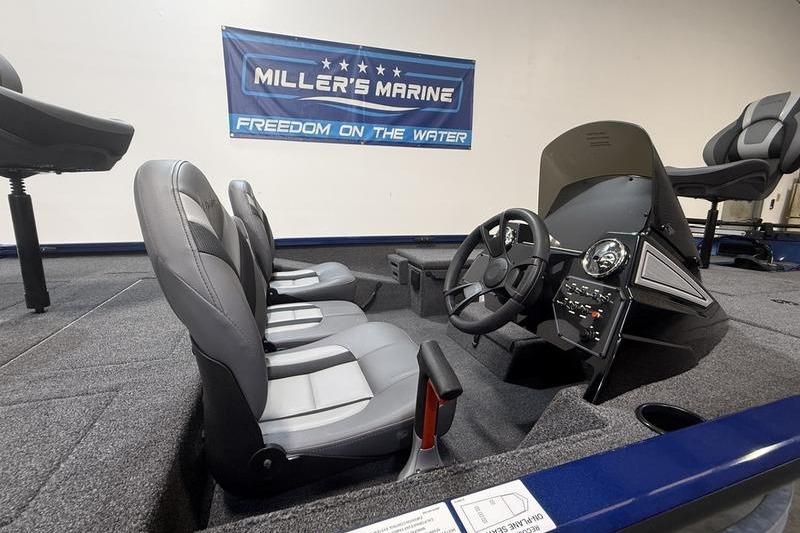 2026 Lowe Stinger 175C boat interior with steering console and seating at Miller's Marine showroom.