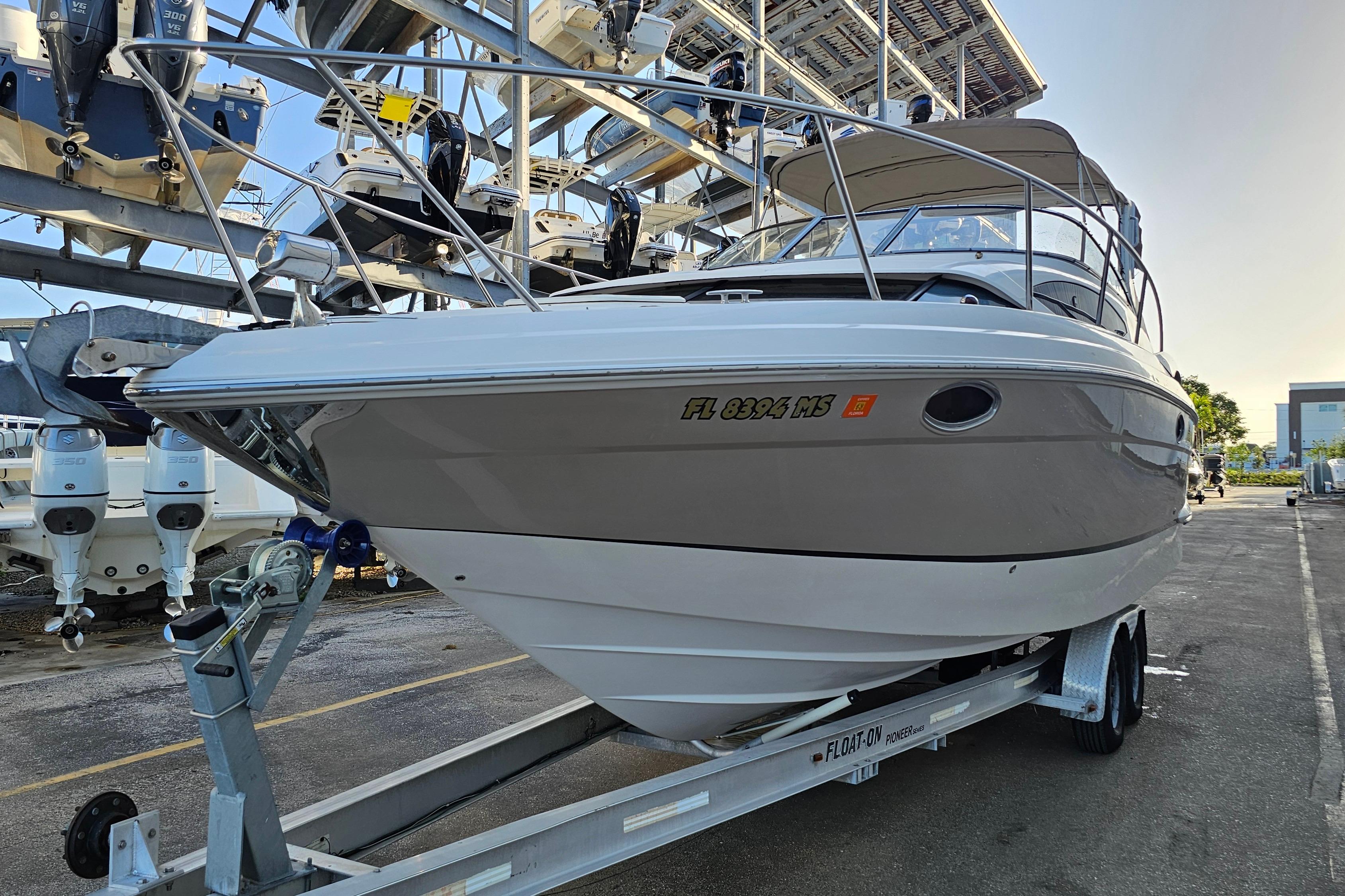 2005 Regal 3060 Window Express boat on trailer in marina storage.