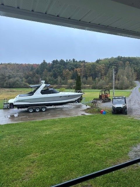 2006 Formula 330 Sun Sport boat on trailer in a grassy area.