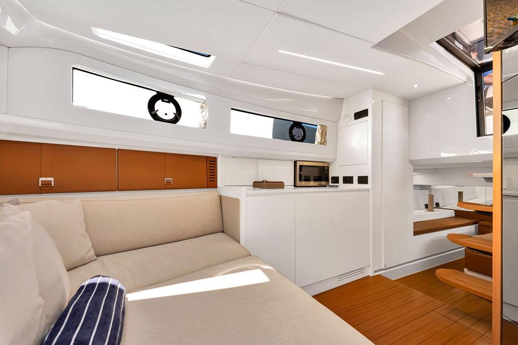 Luxurious interior of 2021 Bluegame BG 42 yacht with modern furnishings and wooden accents.