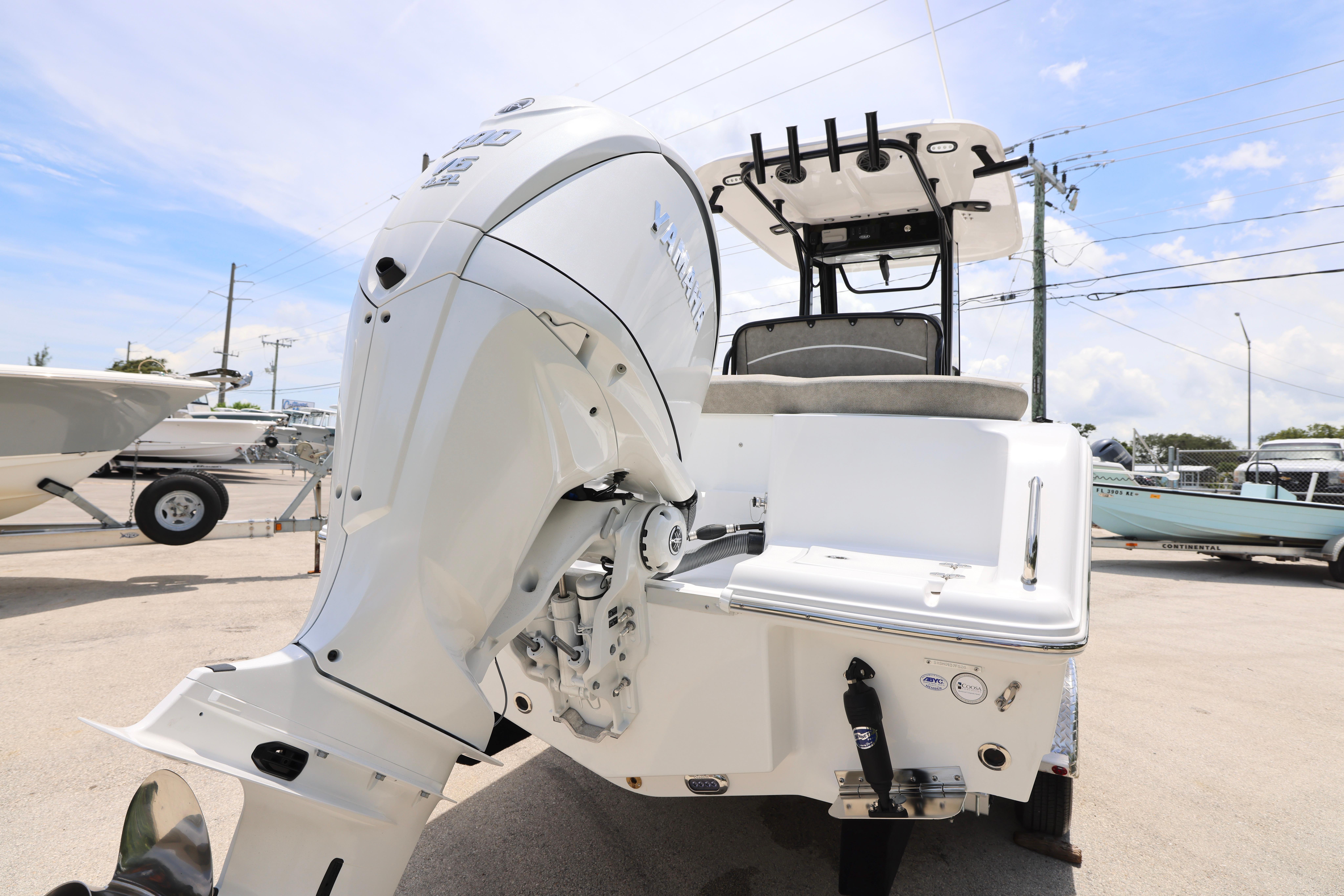 2026 Sea Hunt Ultra 245 SE boat with powerful outboard motor, parked outdoors.
