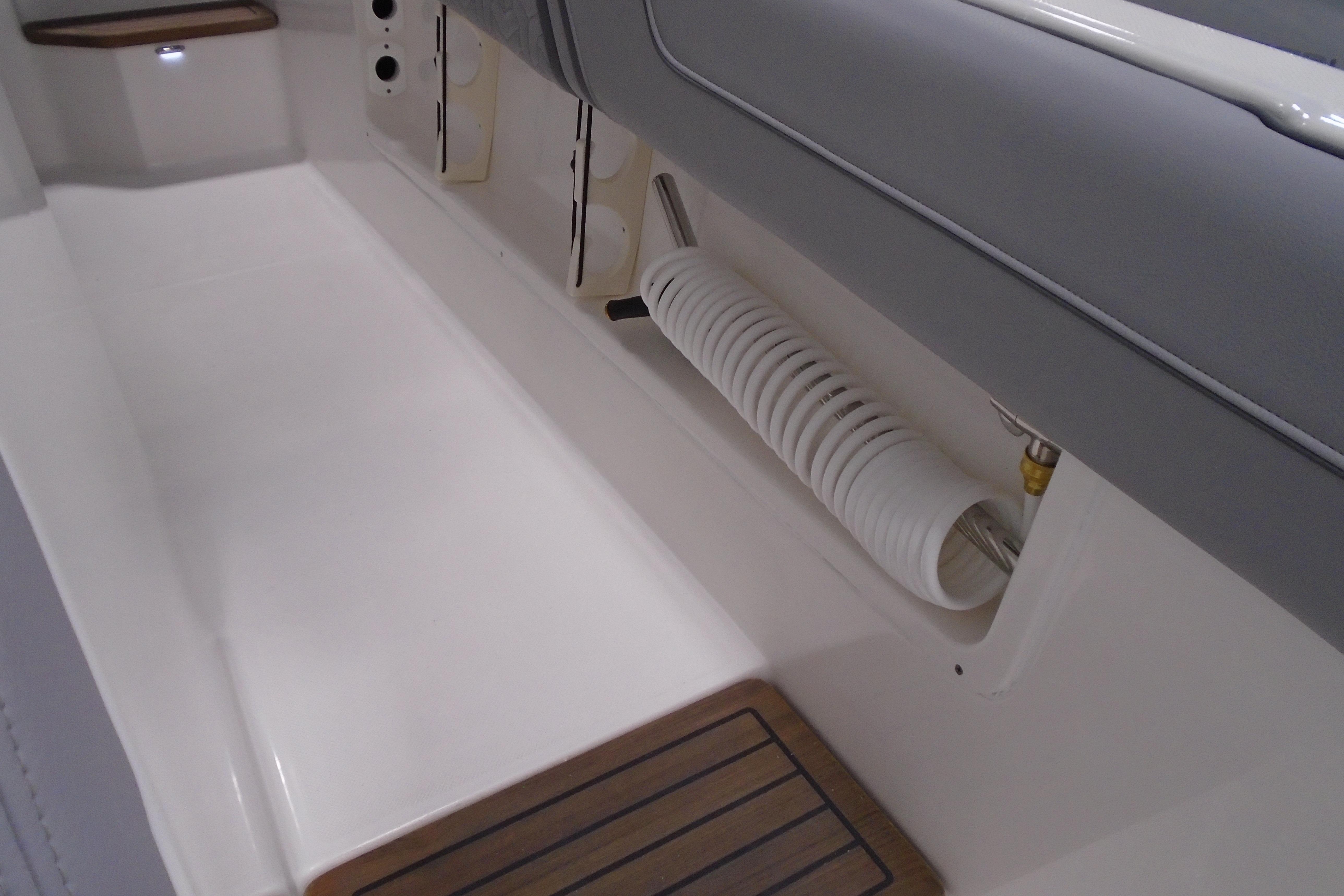 2026 Regal 38 SAV boat interior with storage and coiled hose.