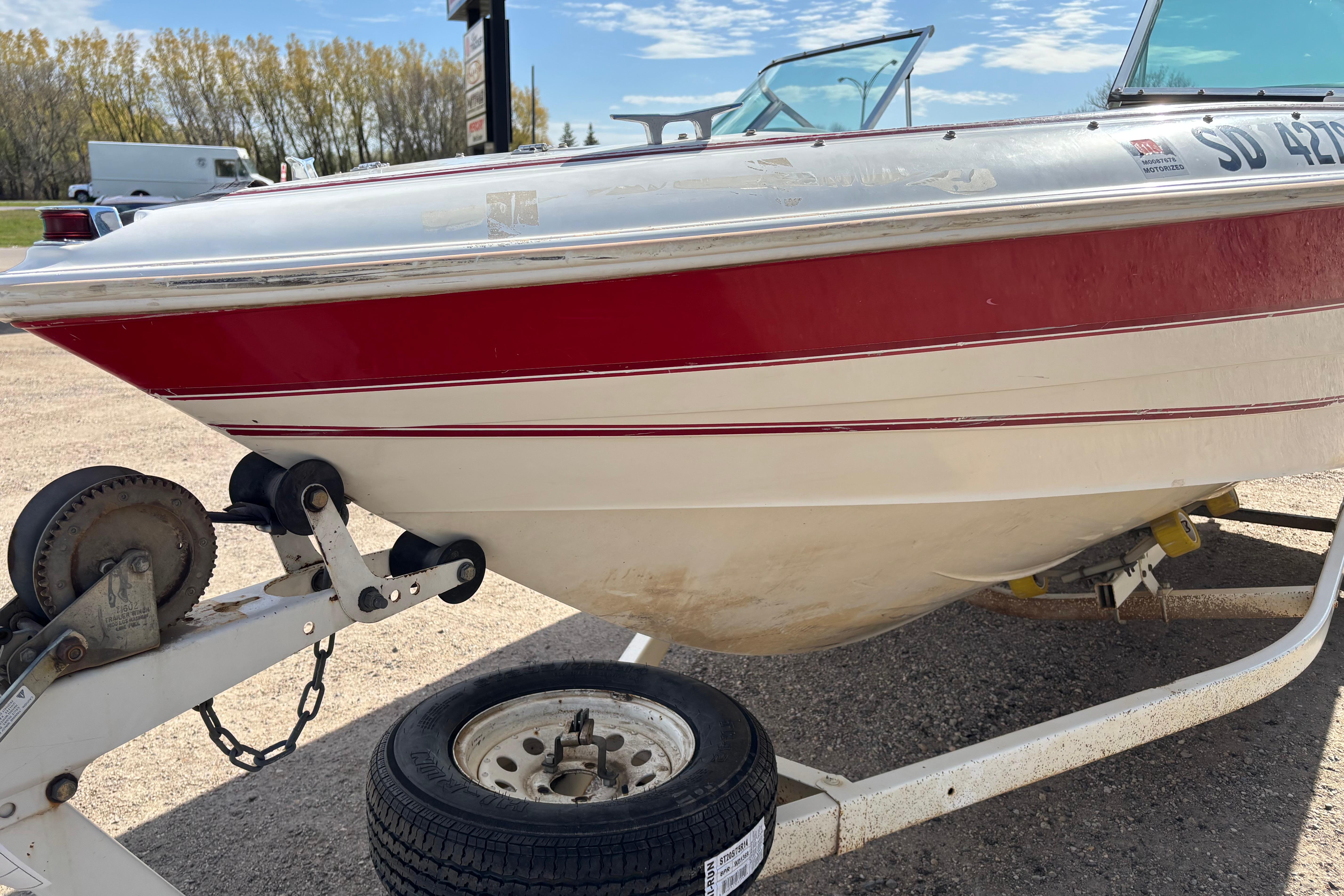 1993 Larson SEi 200 Cuddy I/O boat on trailer, red and white exterior.