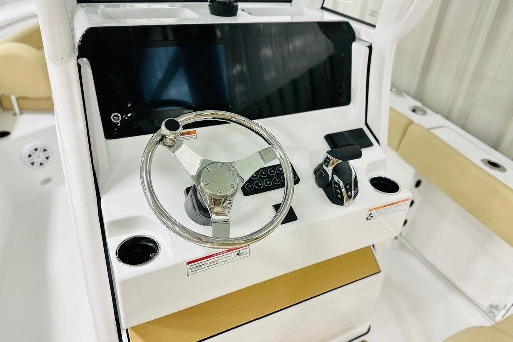 2026 Sportsman Open 232 Center Console boat dashboard with steering wheel and controls.
